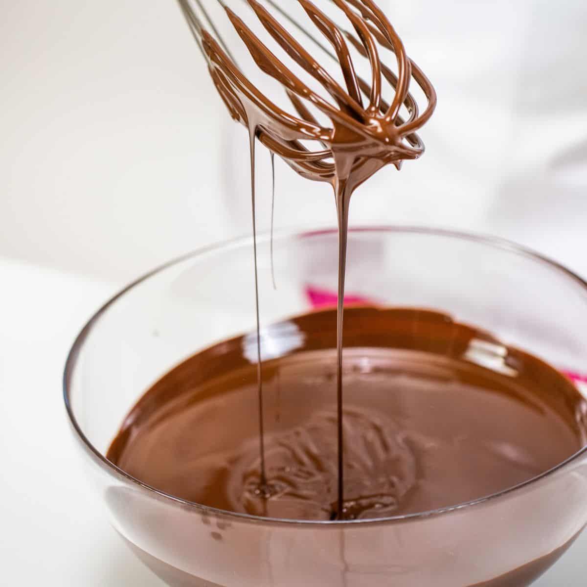 Stirring melted chocolate chips with a whisk