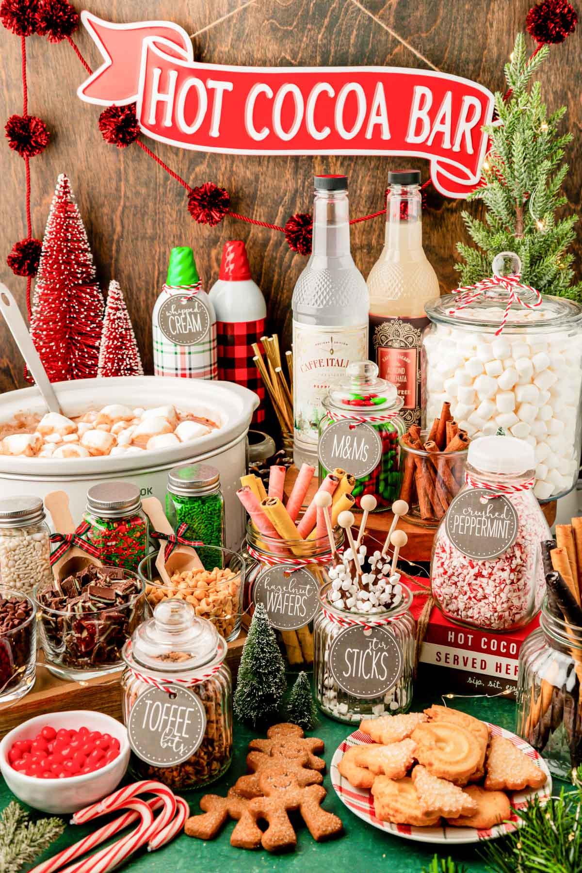 Table set for a holiday gathering with multiple peppermint mocha mugs and small treats