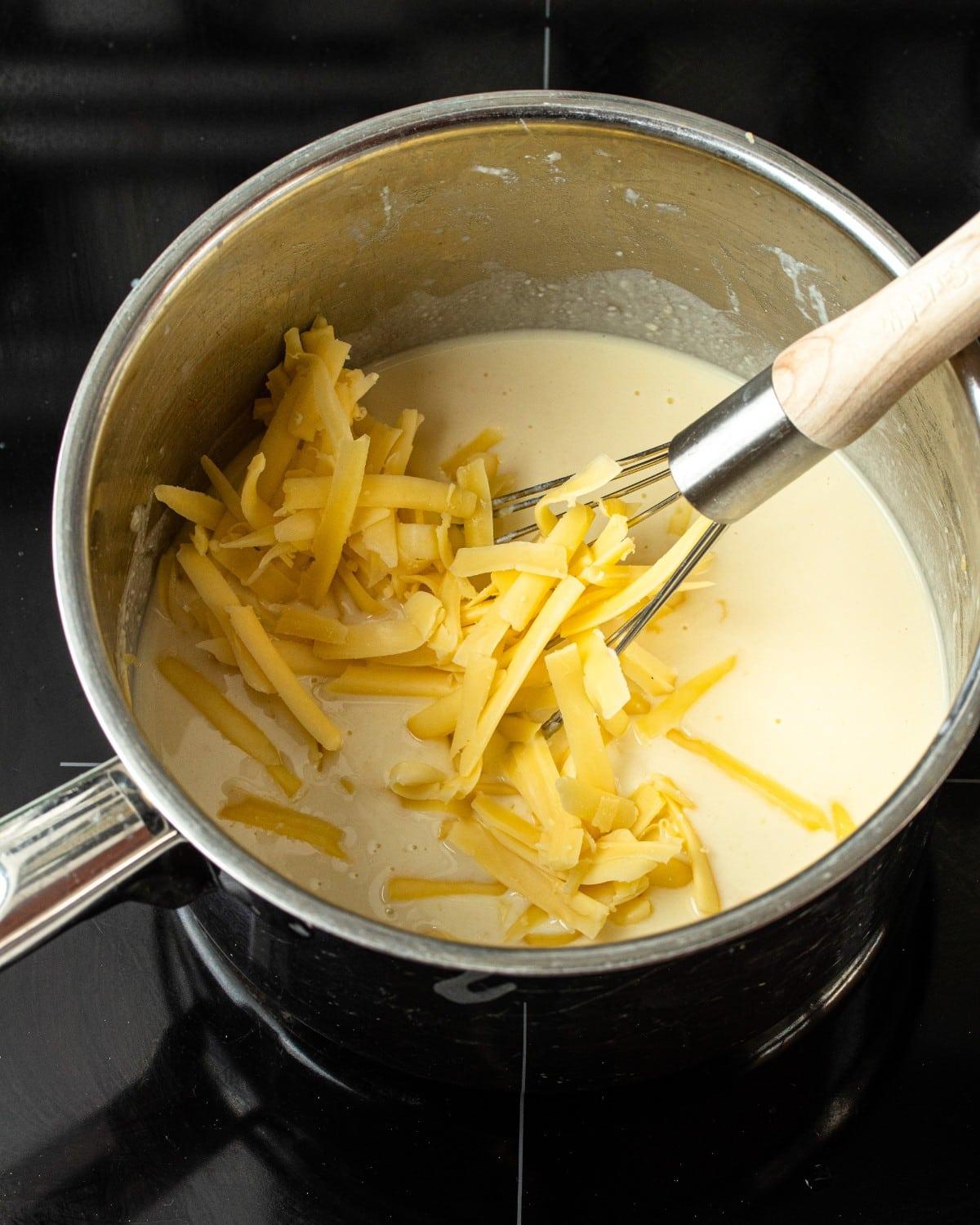 Creamy cheese sauce bubbling in a saucepan