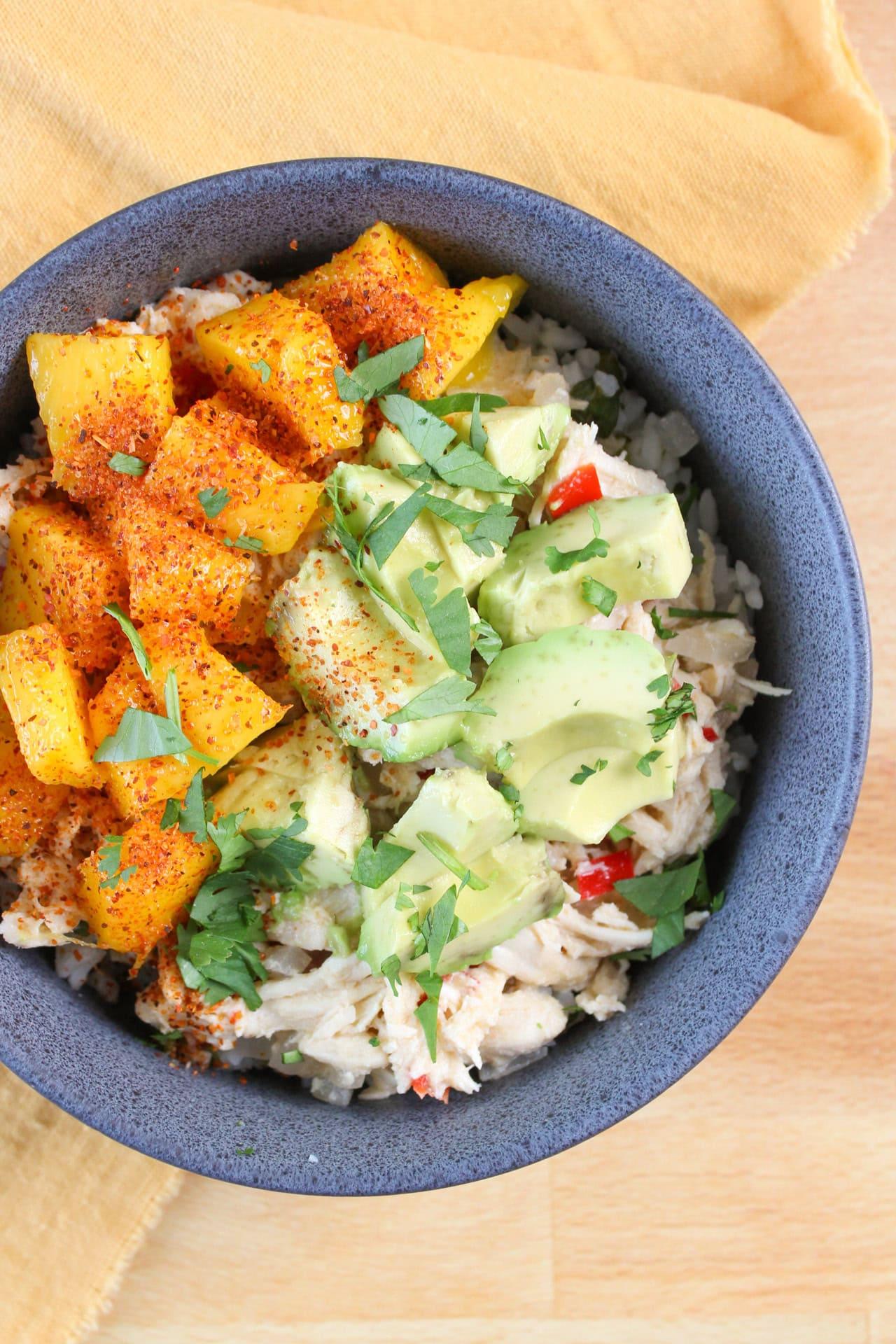 tropical chicken rice bowl with grilled chicken, pineapple, mango, and cilantro