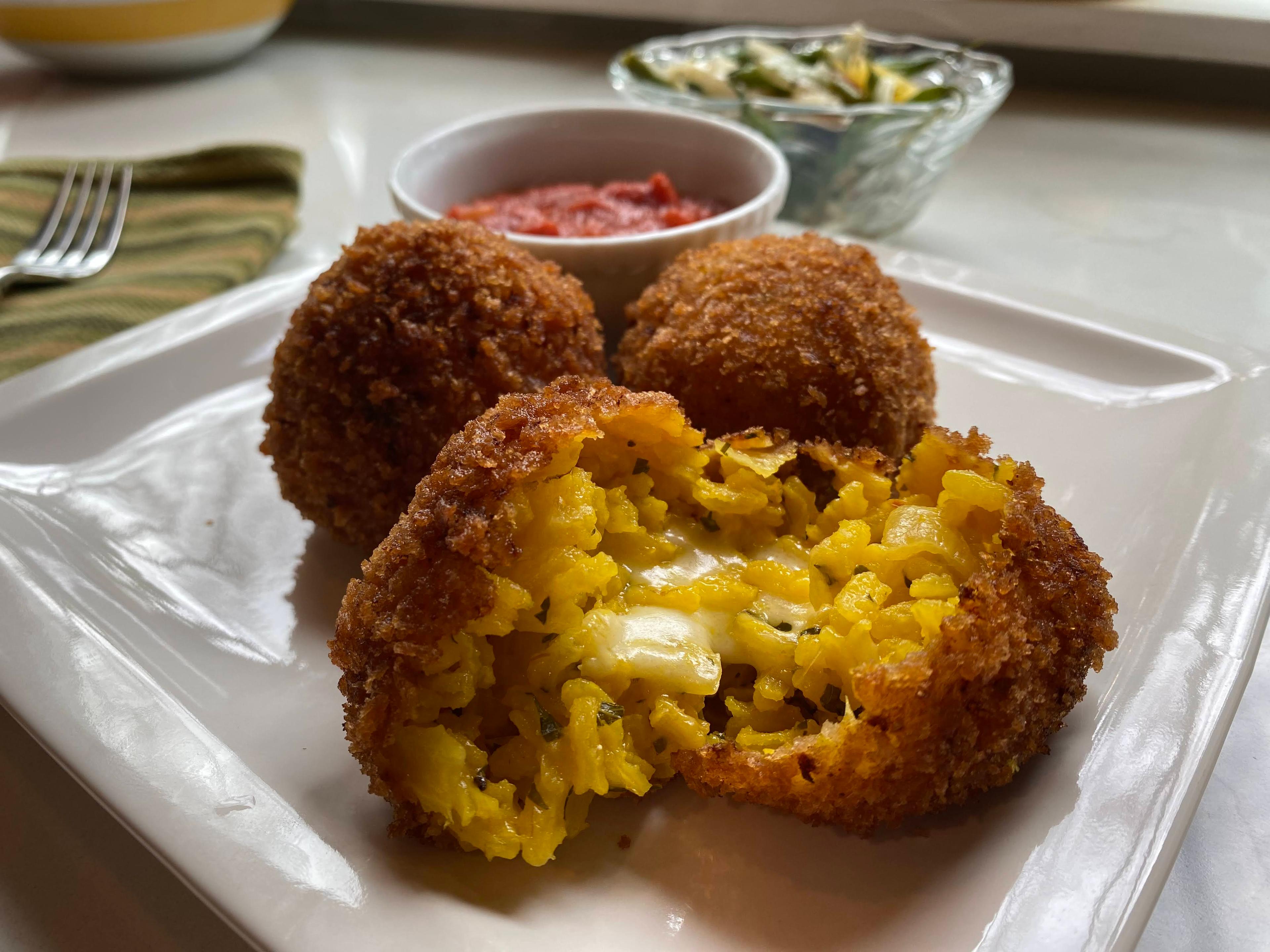 finished turkey arancini with saffron risotto plated beautifully, ready to serve