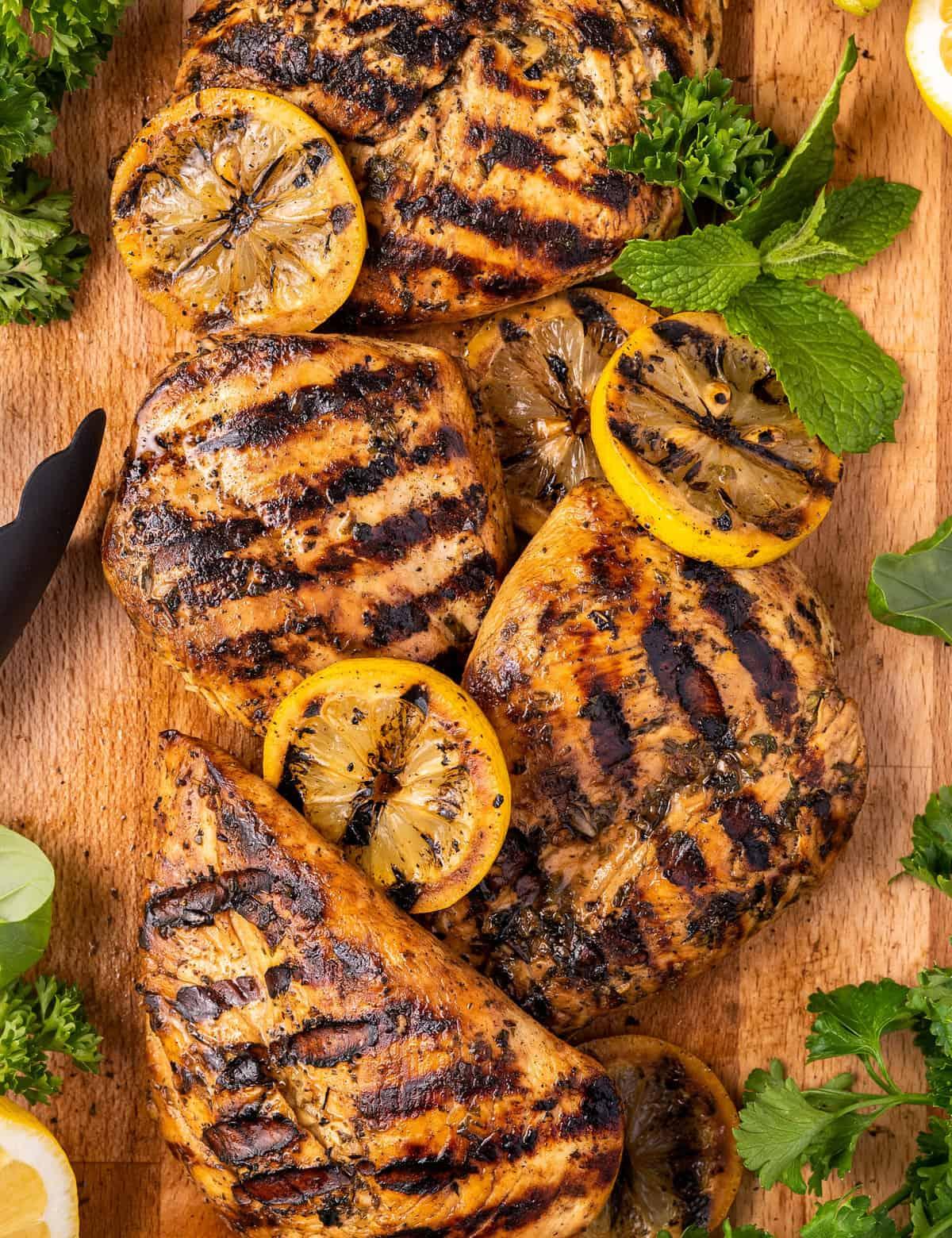 lemon herb chicken grilling on an outdoor grill