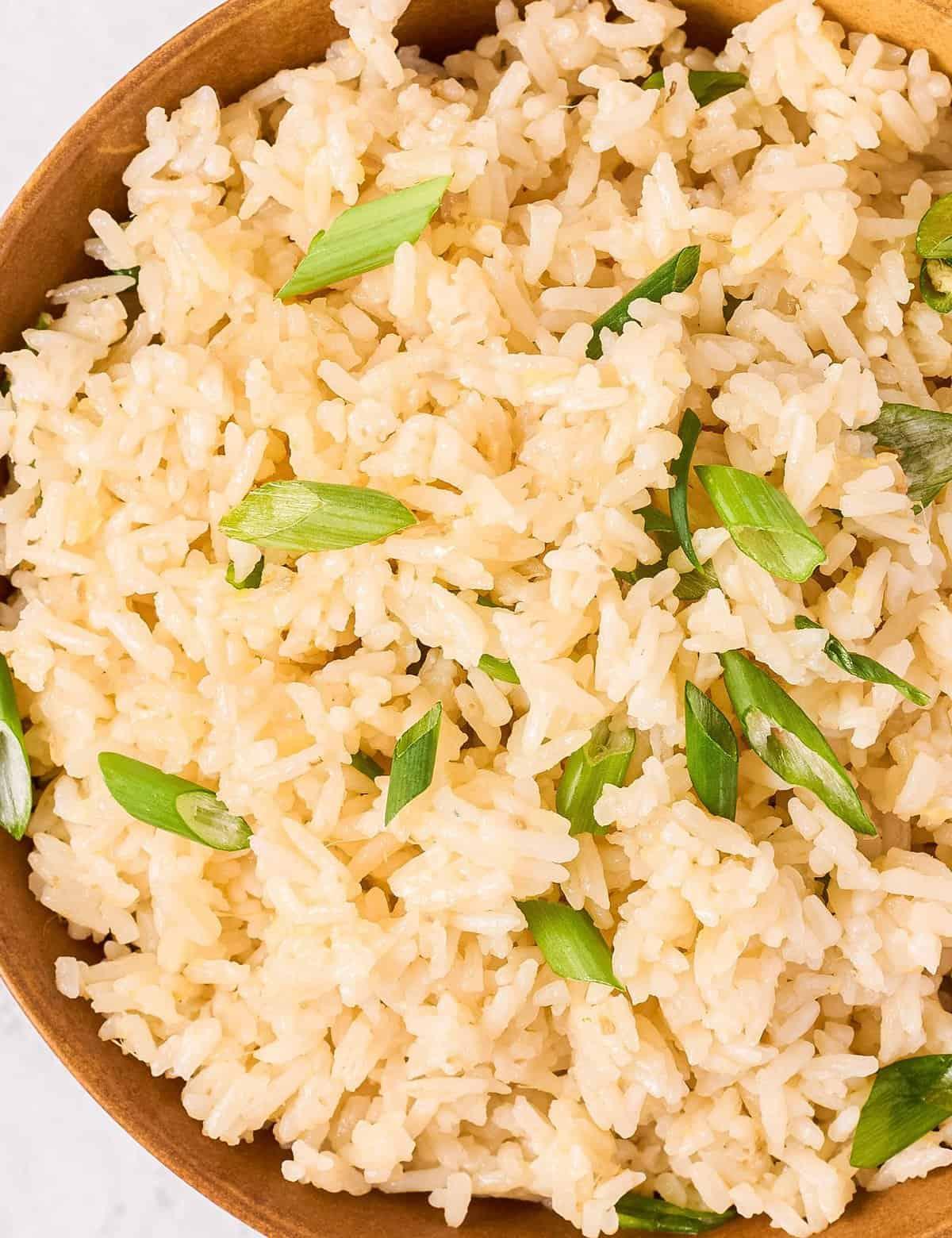 ingredients for instant pot ginger garlic rice on a wooden cutting board
