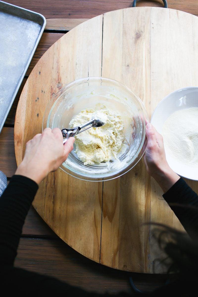 close-up shot of a person gently mixing ricotta gnocchi dough in a bowl