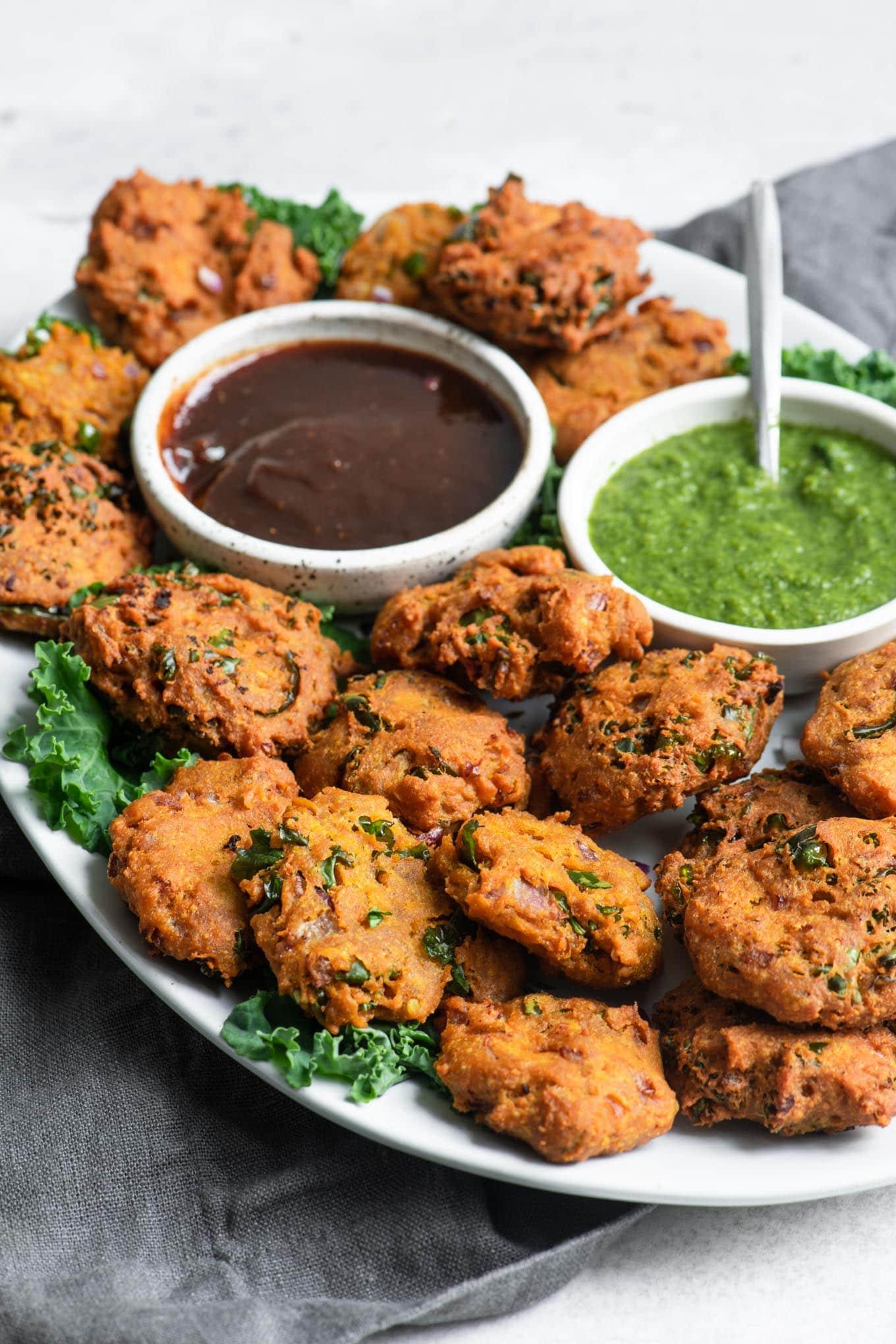 close up of a plate of plant-based meatball pakoras with dipping sauce