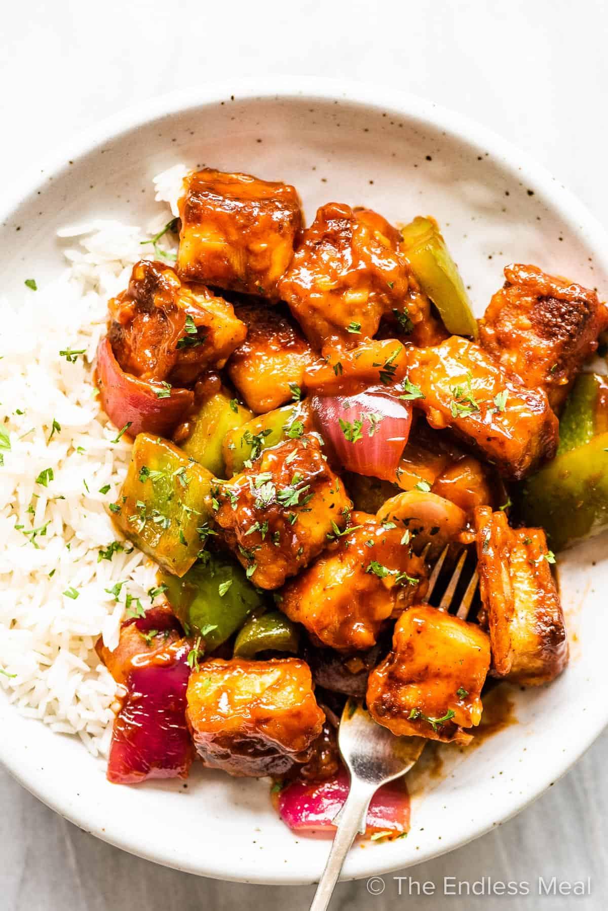 Paneer cubes marinating in sweet chili sauce