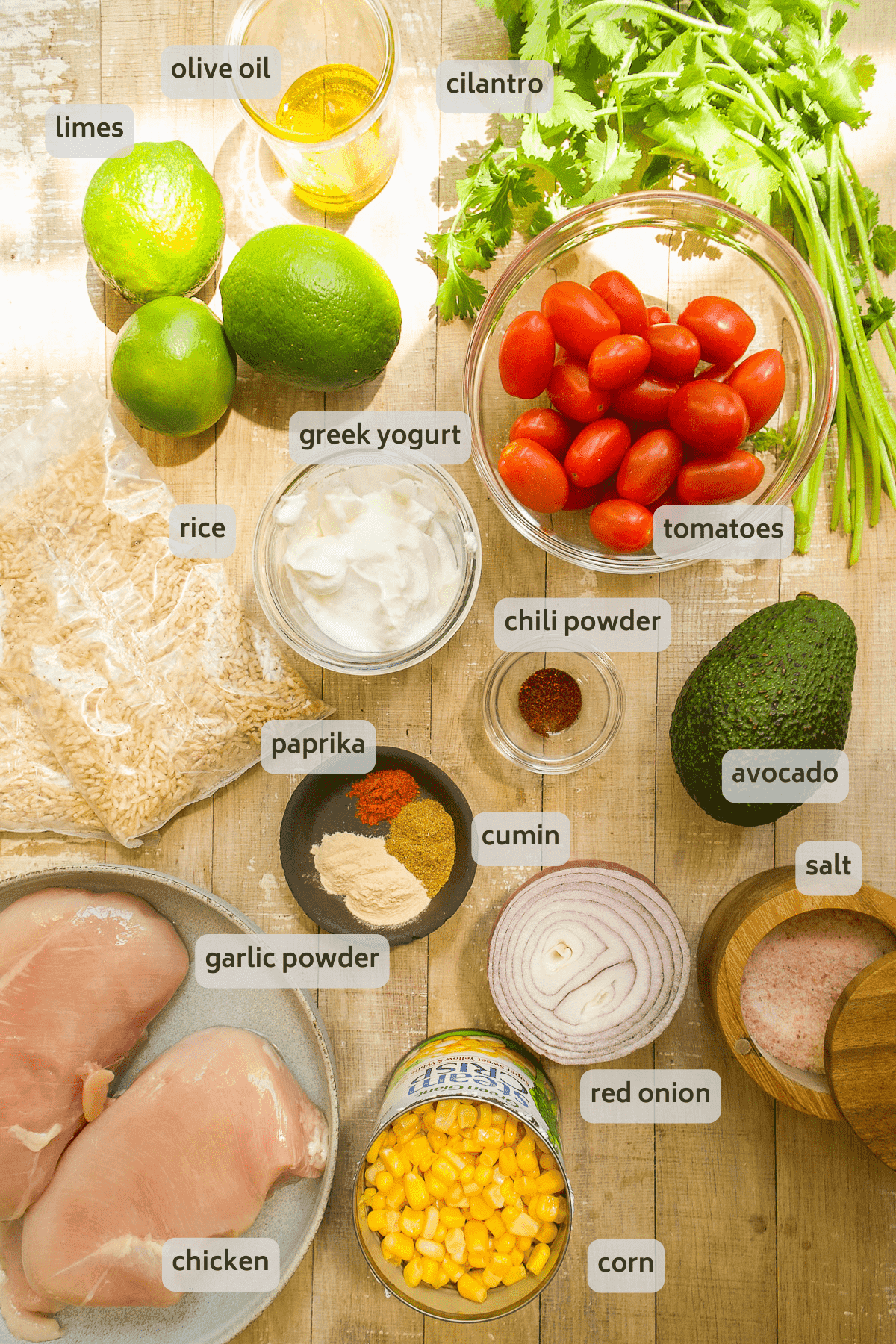 ingredients for chicken taco bowls on a wooden surface