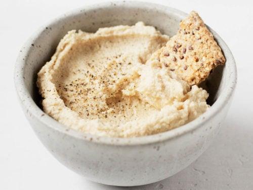 mixing cashew cheese dip in a bowl