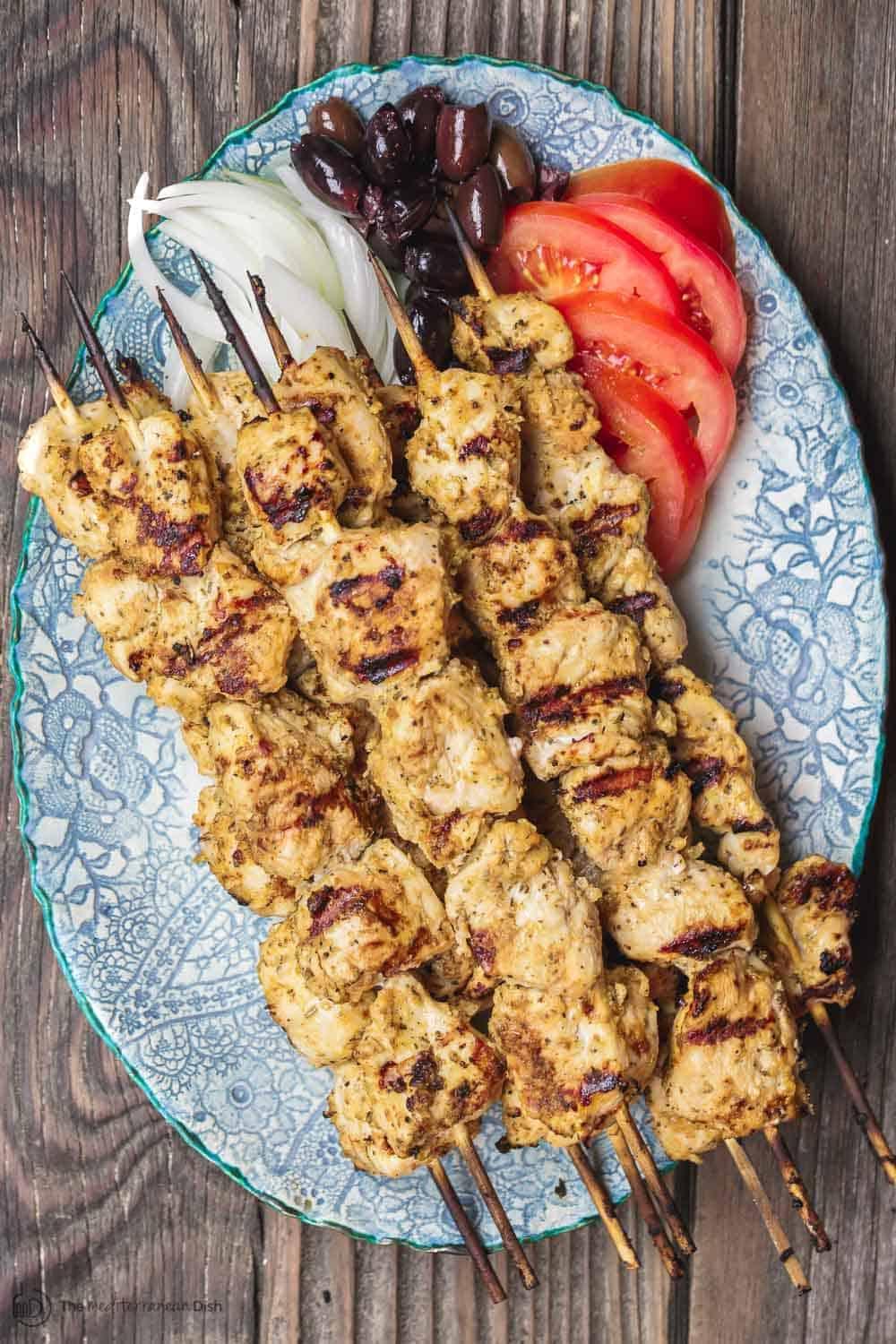 Chicken souvlaki skewers grilling on a barbeque