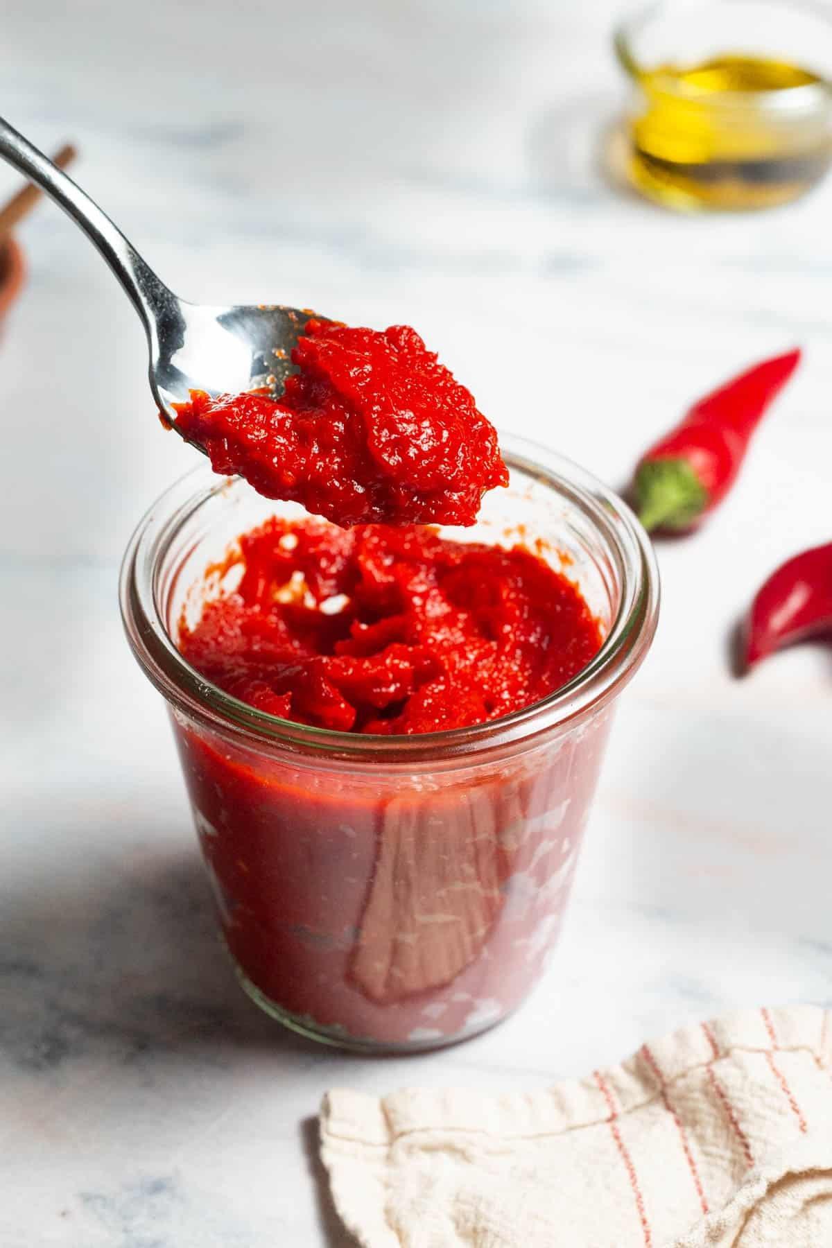 Homemade paprika paste in a bowl with ingredients