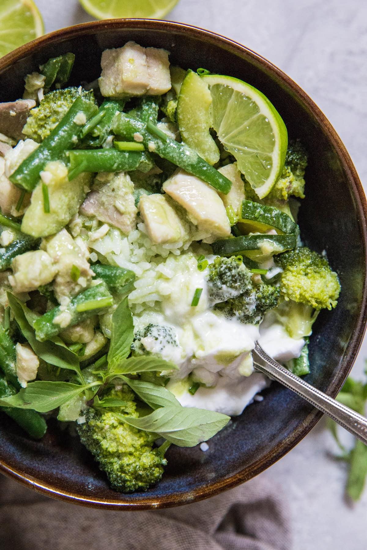 Close-up of Green Curry Fish with Zucchini being served in a bowl