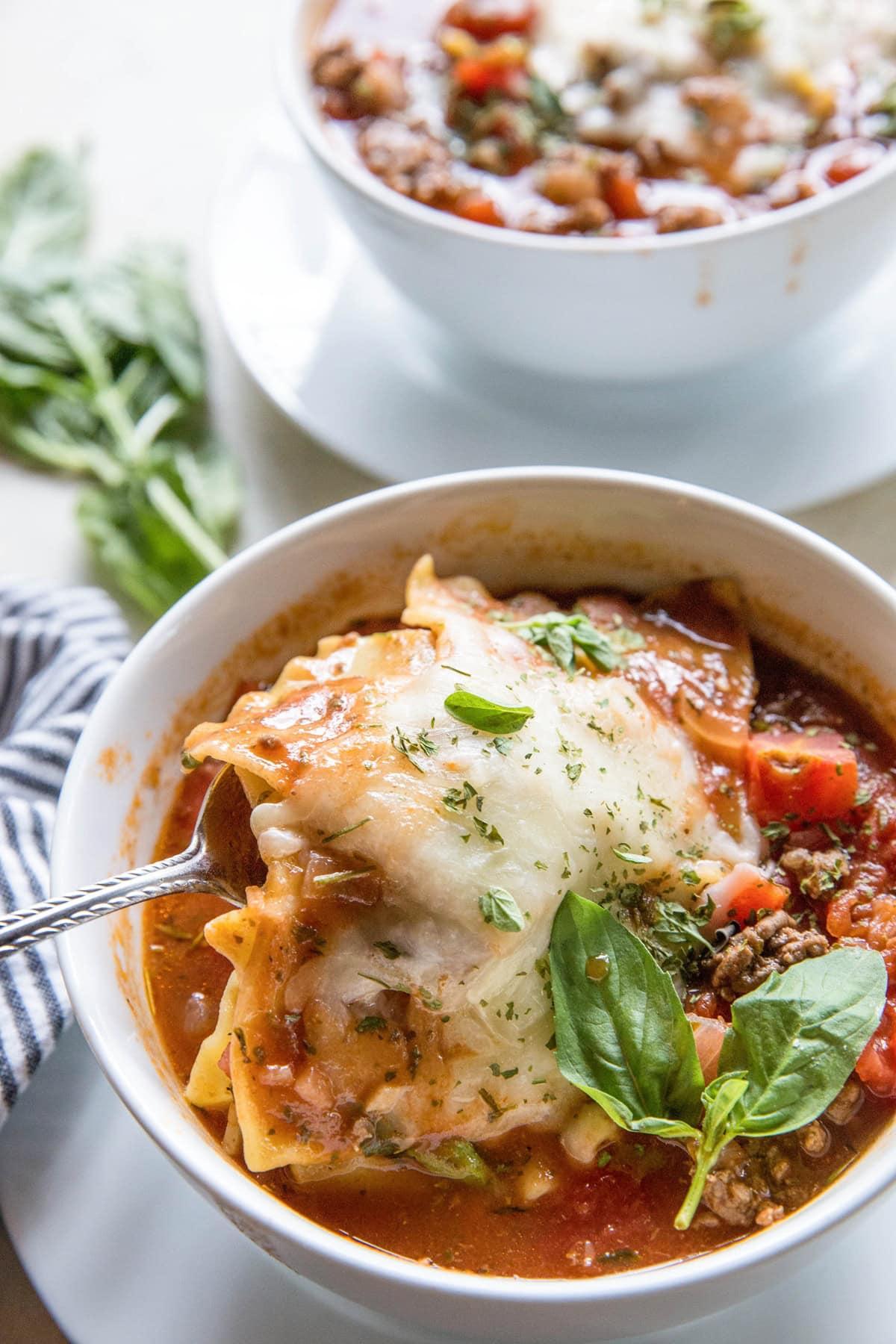 ladle scooping lasagna soup into bowl