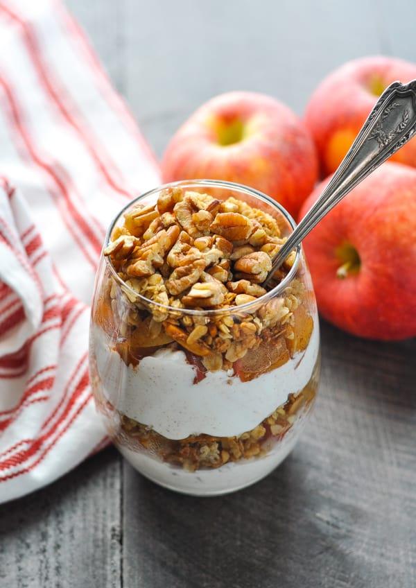 A person enjoying an apple crisp parfait