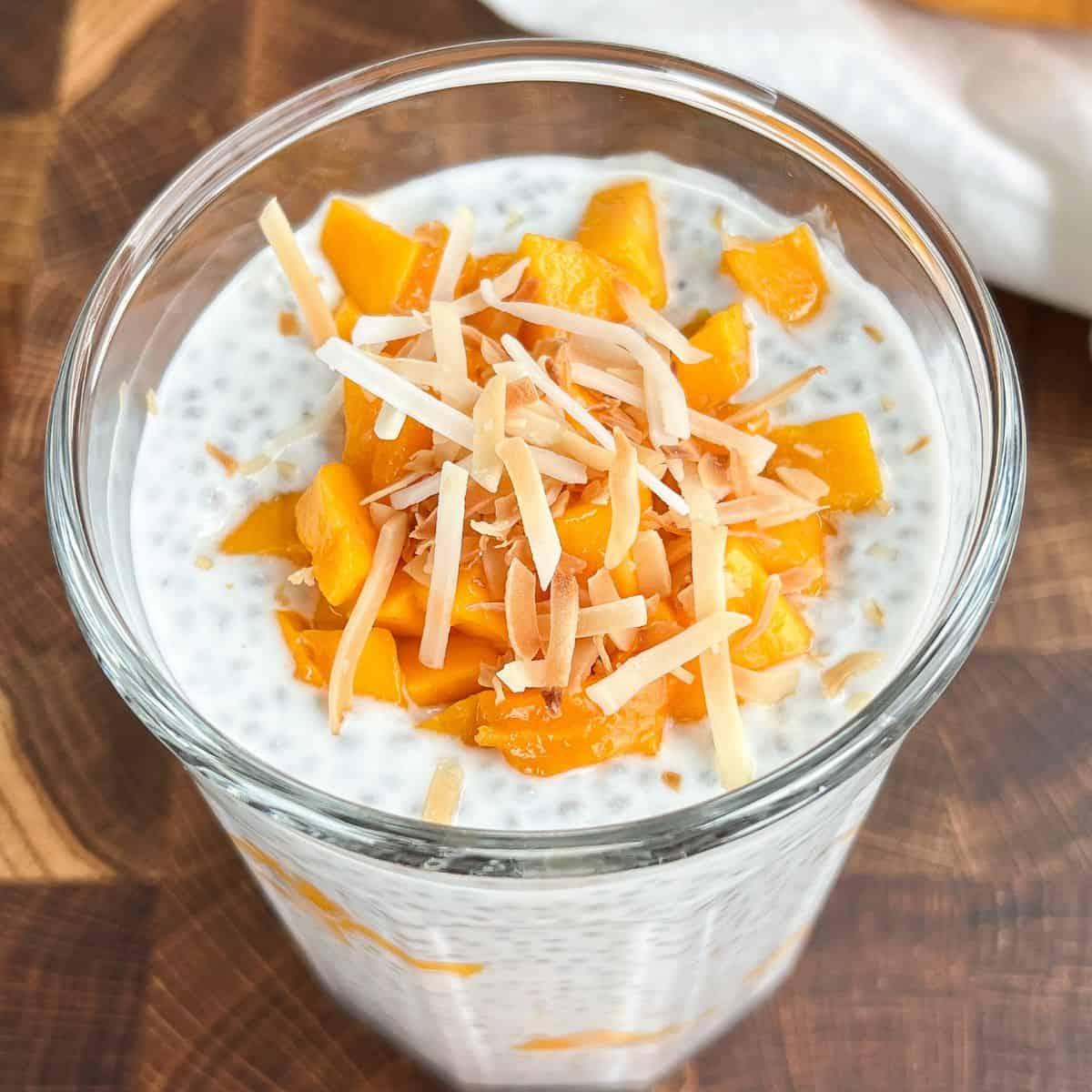 overhead shot of mango coconut chia pudding being prepared in a kitchen