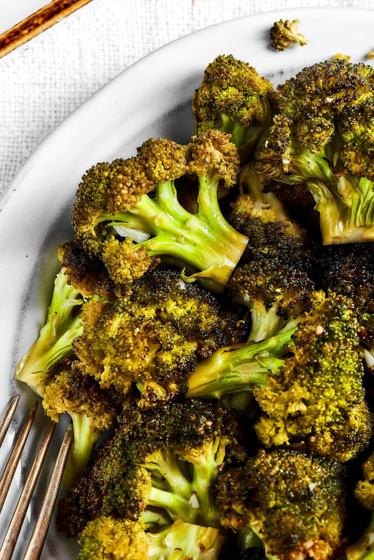 Close-up shot of roasted broccoli with garlic and herbs