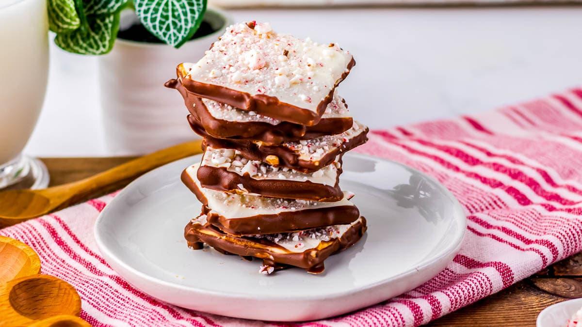 perfectly snapped peppermint bark pieces on a white platter, close-up texture