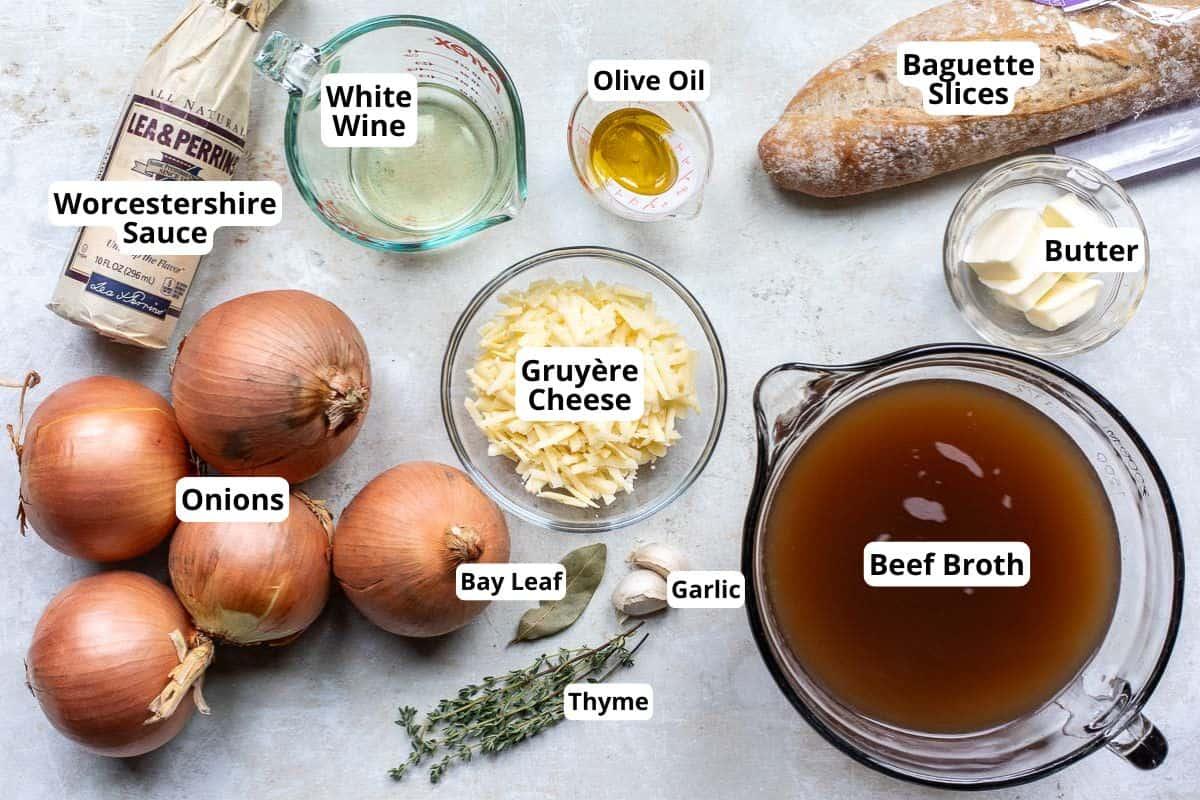Ingredients for french onion soup, including onions, beef broth, thyme, bay leaf, and gruyere cheese