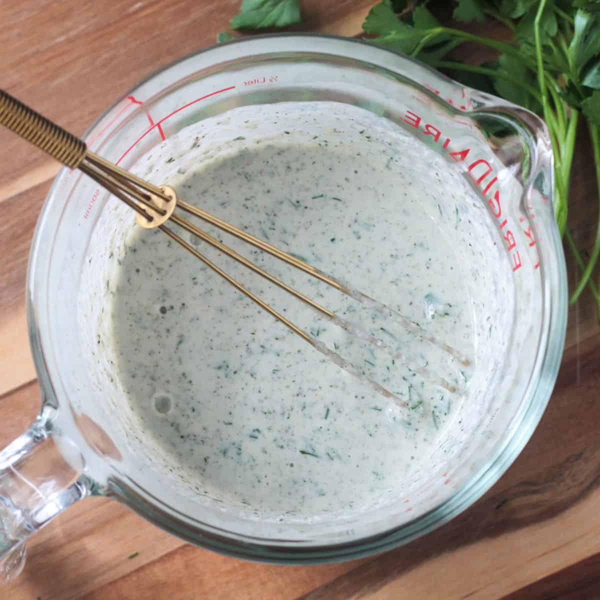 hemp seeds being poured into a mixing bowl with cake batter