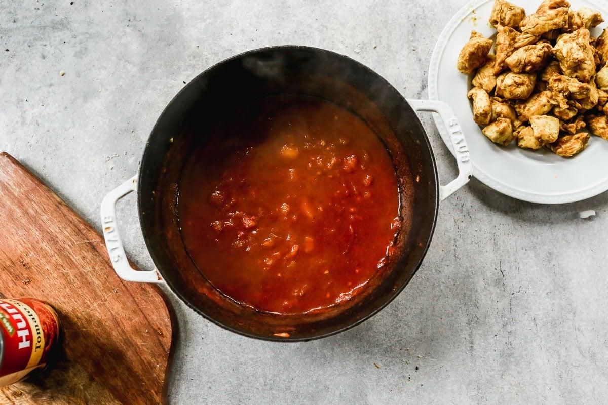 butter chicken simmering in a pot on the stovetop