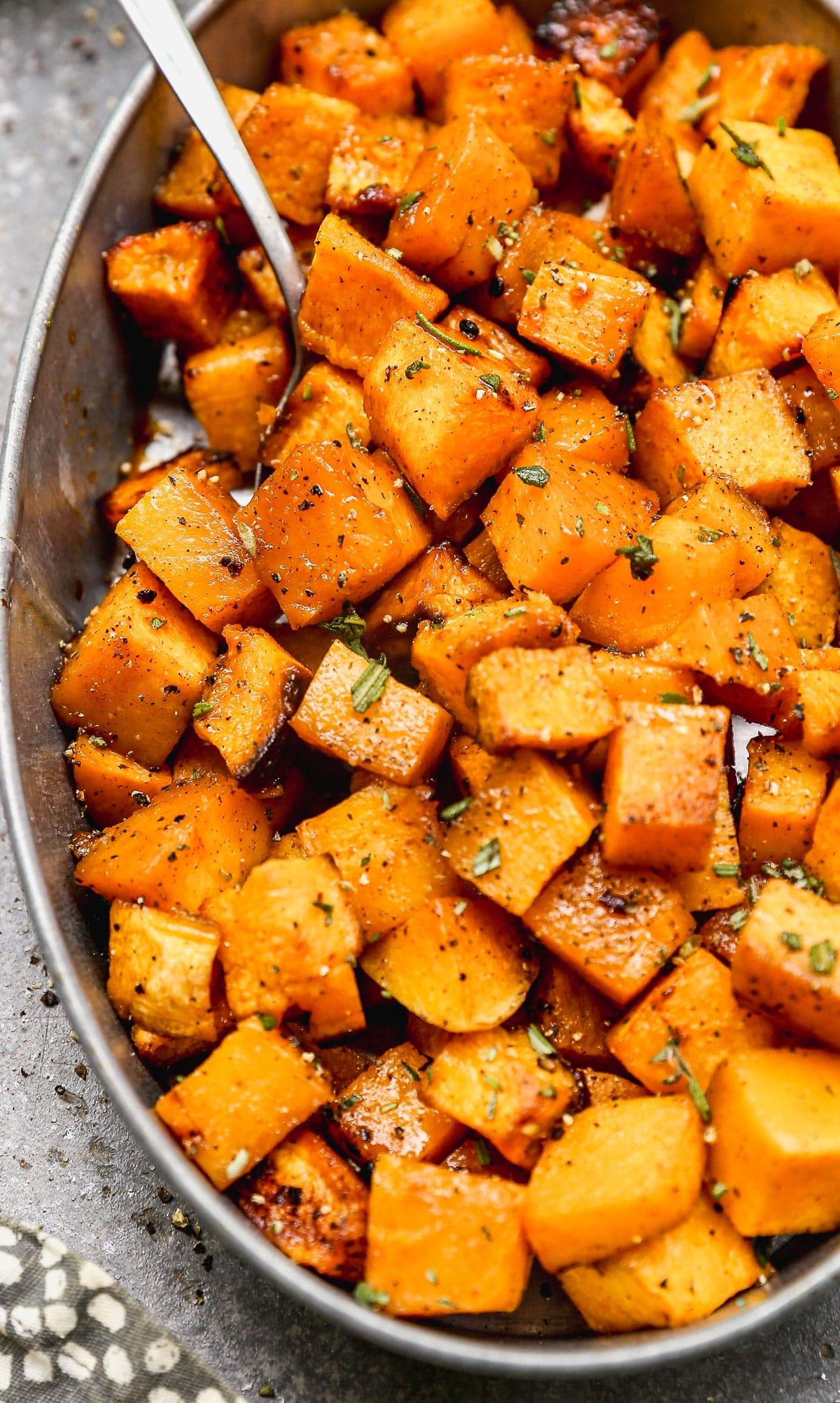 Close-up of roasted butternut squash cubes tossed with maple syrup and spices