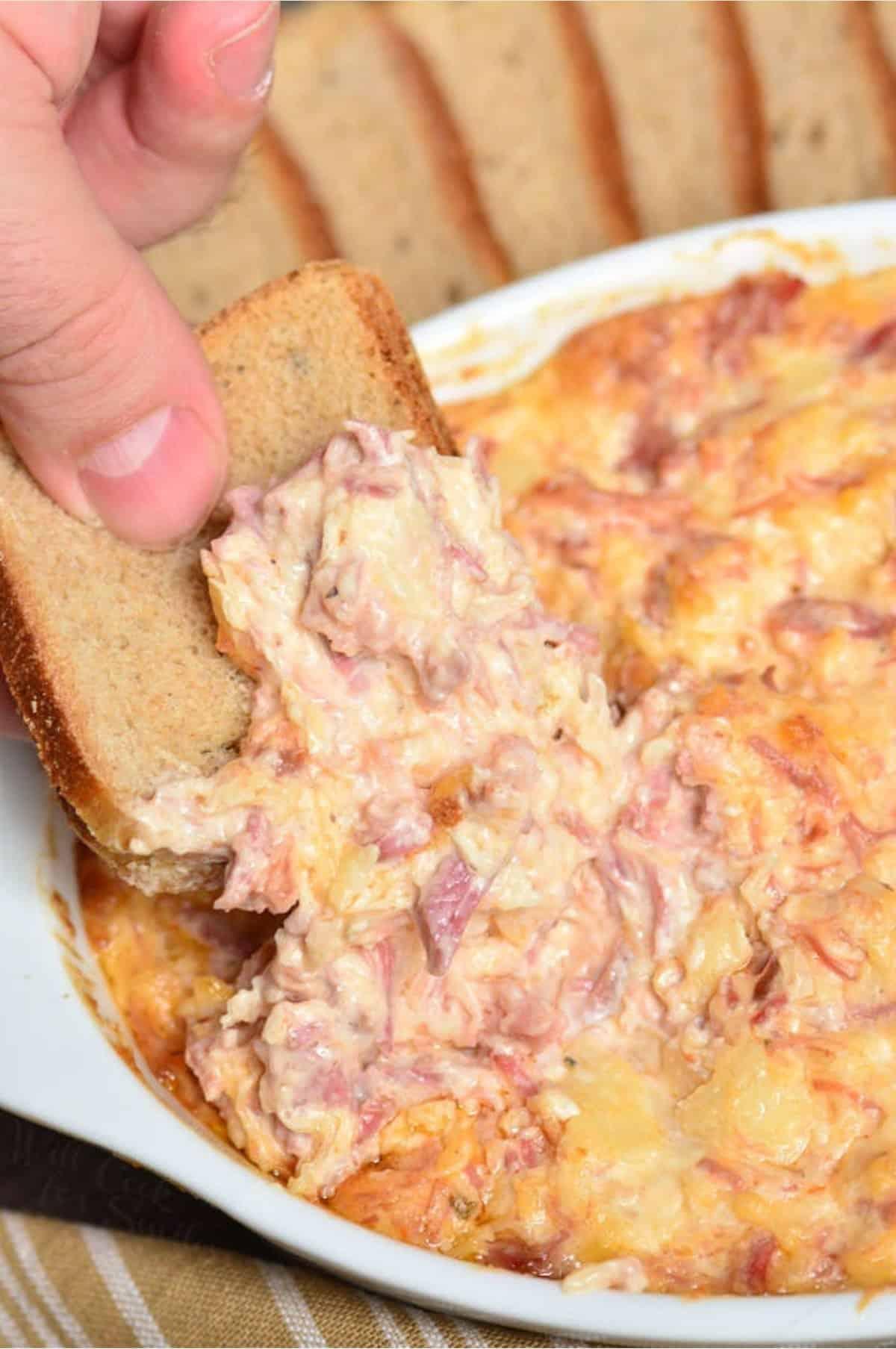 Close-up shot of a bowl of Reuben dip with melted cheese