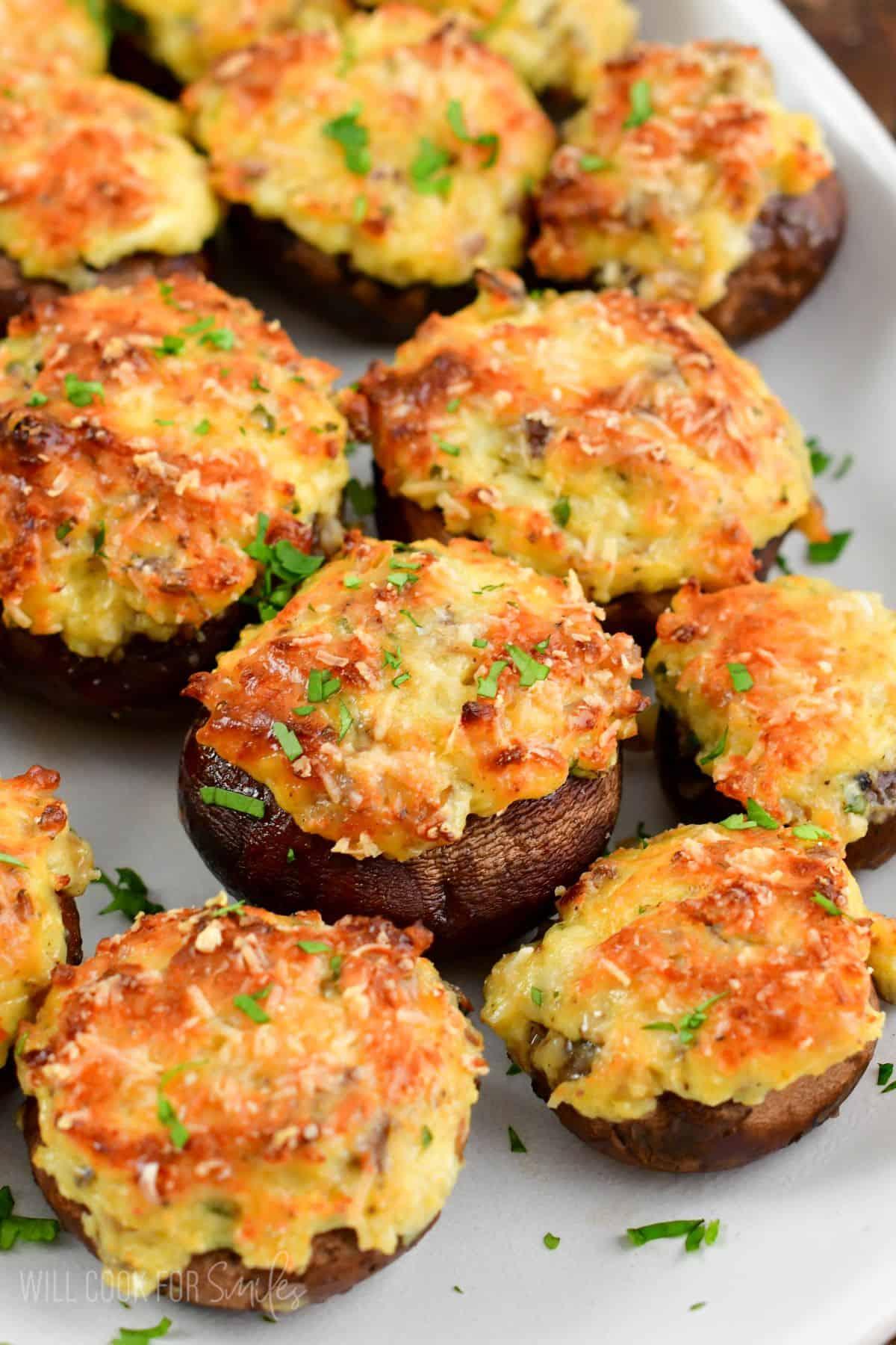 close-up of cooked stuffed mushrooms garnished with fresh herbs
