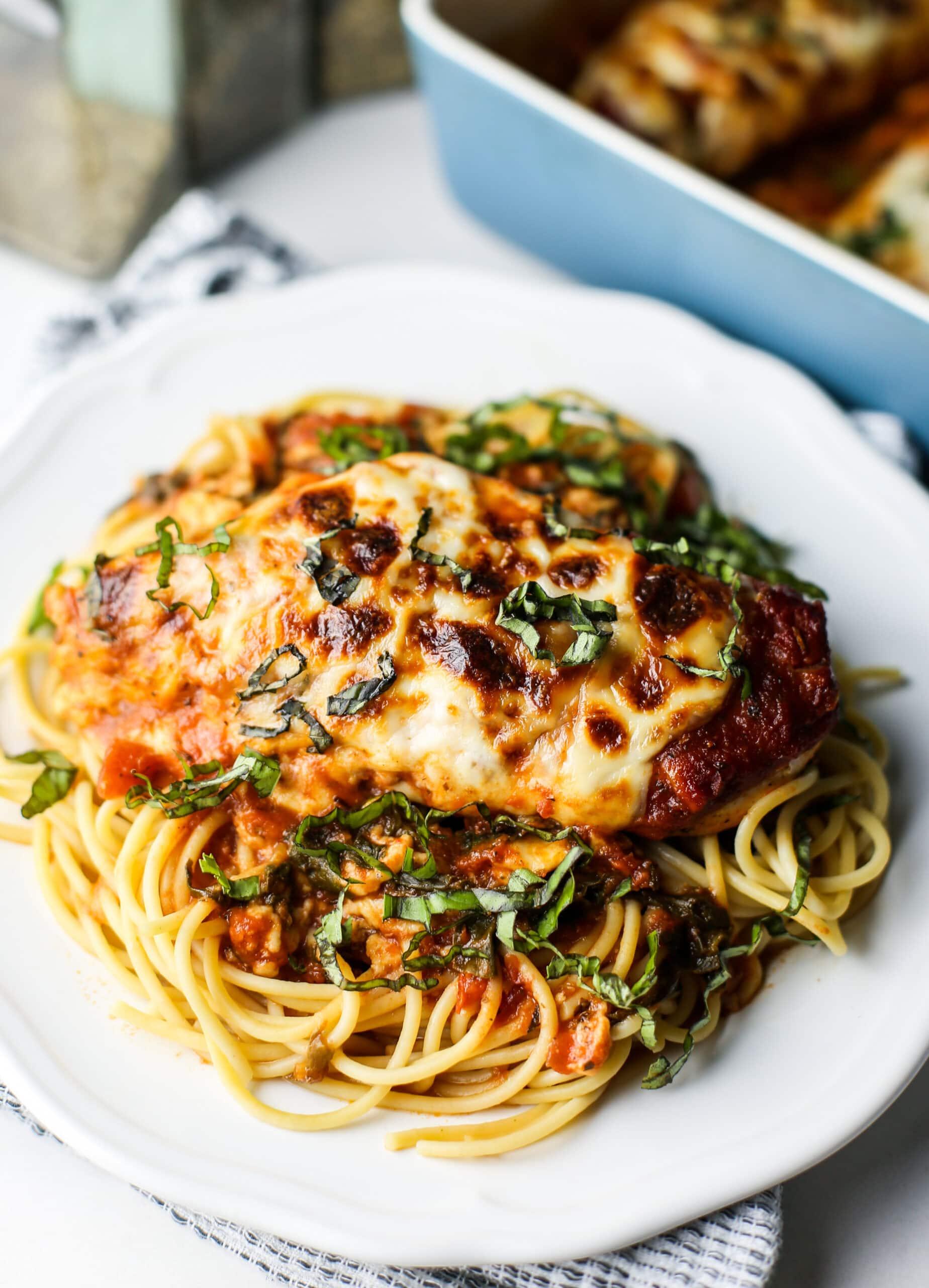close up of golden brown mozzarella chicken bits on a plate with marinara sauce