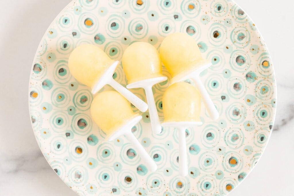 a batch of pear popsicles lined up on a tray