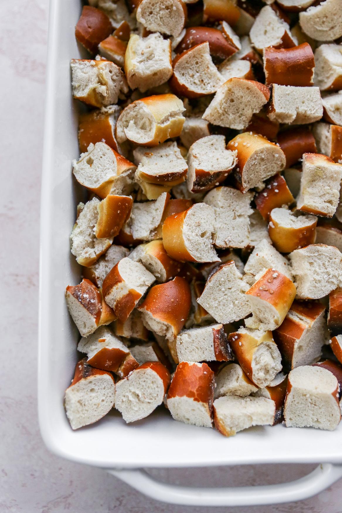 uncooked beer-pretzel strata in a baking dish, ready for the oven