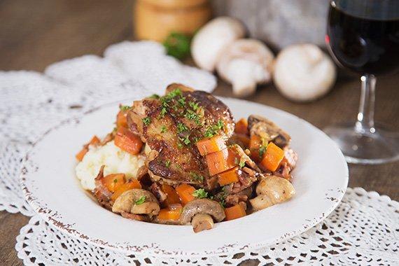 Coq au Vin with Guinea Fowl plated with mashed potatoes and garnished with parsley