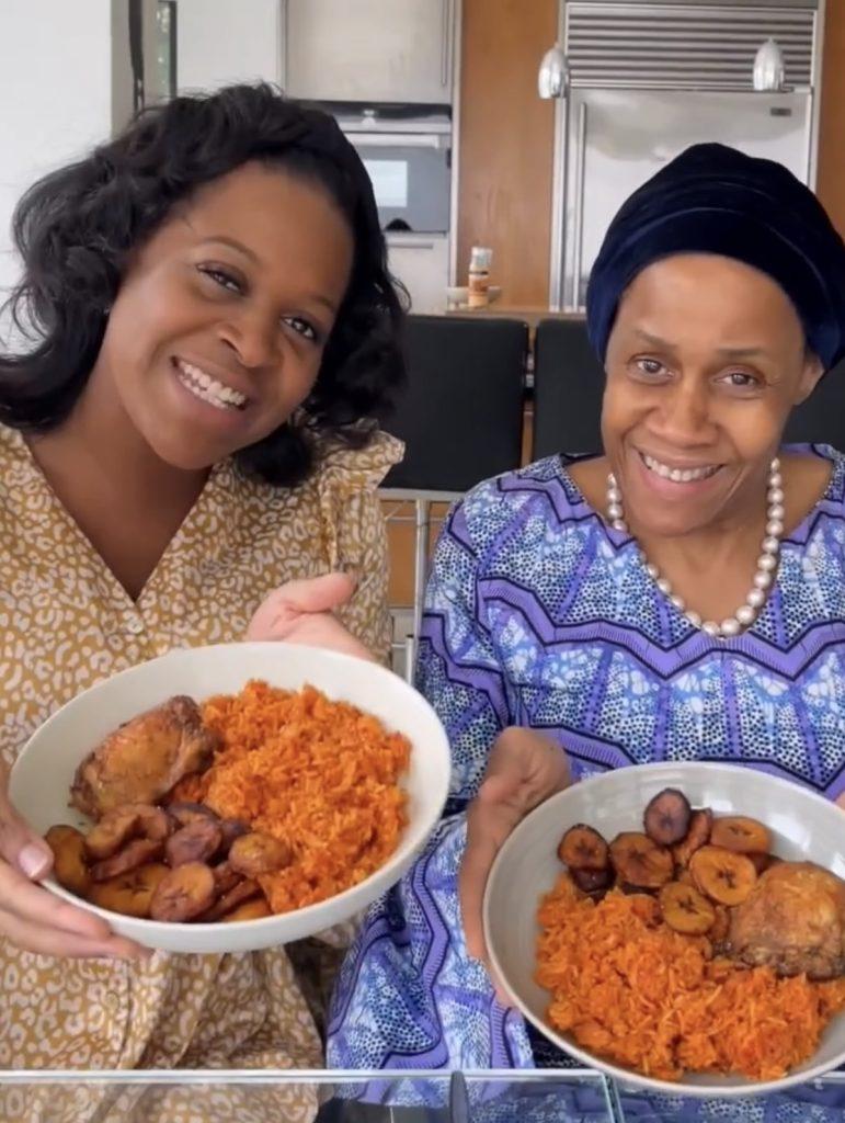 A person serving a plate of Creamy Tomato and Basil Jollof Rice.