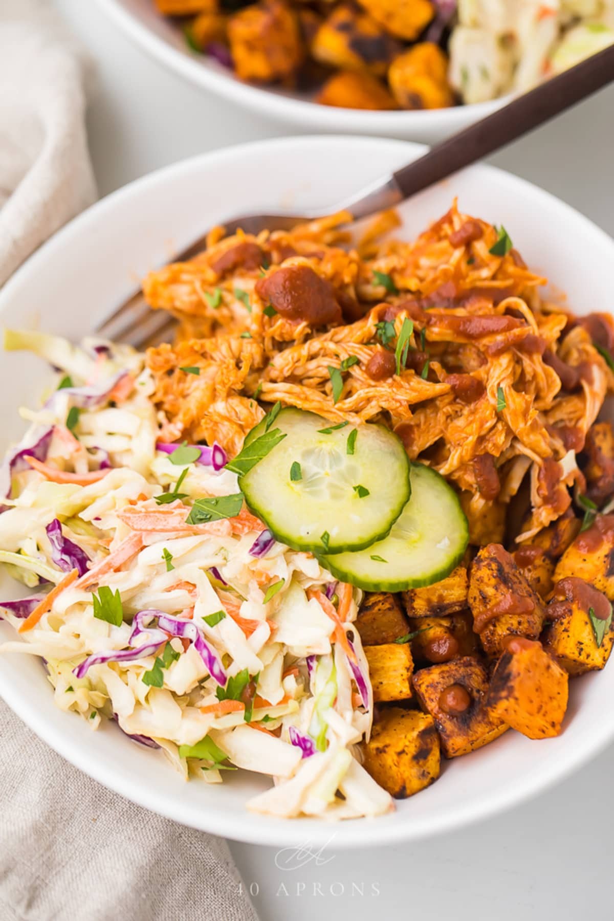 A vibrant and appetizing photo of a BBQ Chicken and Coleslaw Bowl, highlighting the juicy chicken, crisp coleslaw, and any other colorful garnishes.