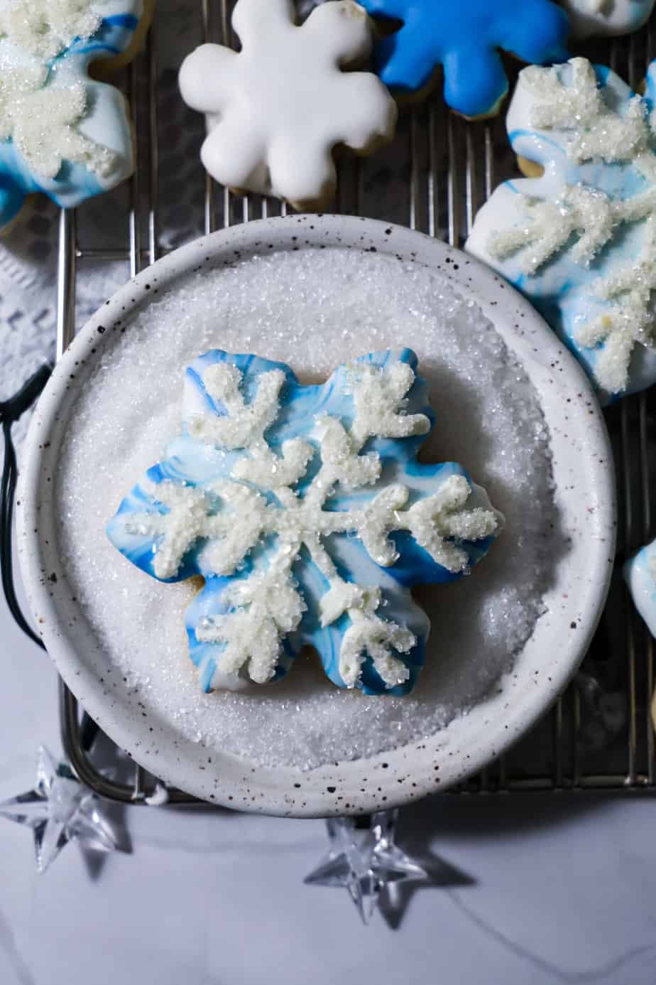 beautifully decorated snowflake sugar cookies with a shiny gloss, close up on a holiday table