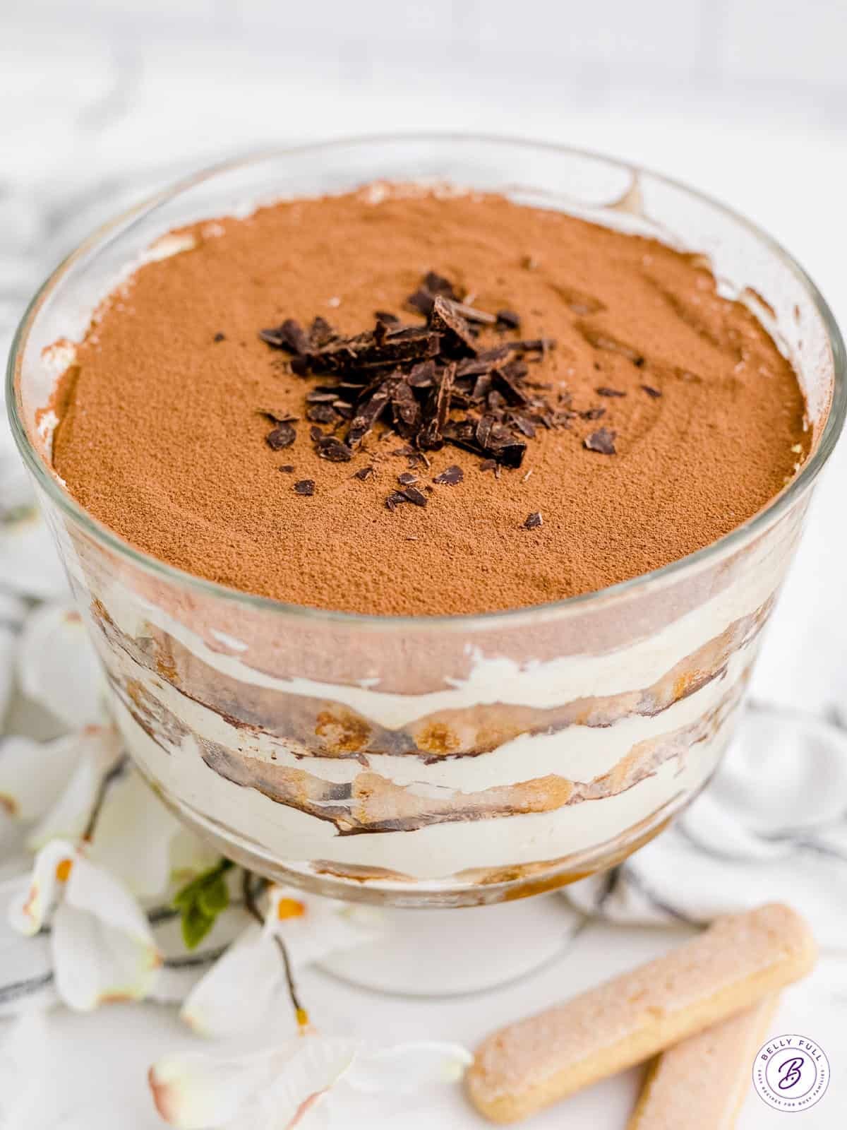 Tiramisu bagel trifle being assembled in a glass dish