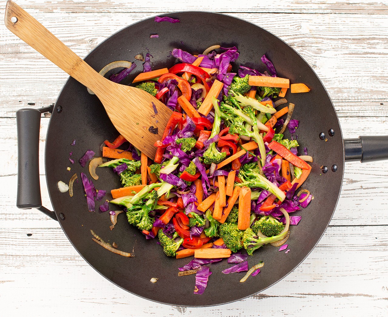 overhead shot of spicy peanut stir-fry with colorful vegetables and peanuts