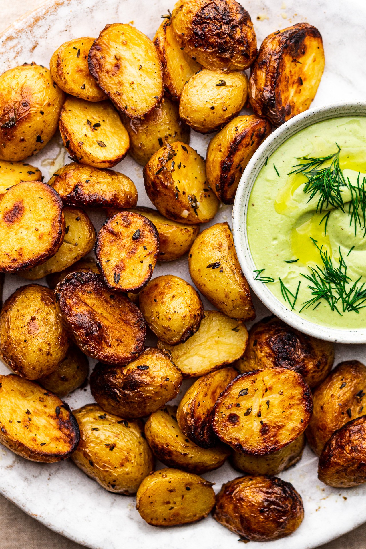lemon and dill roasted new potatoes on a rustic plate