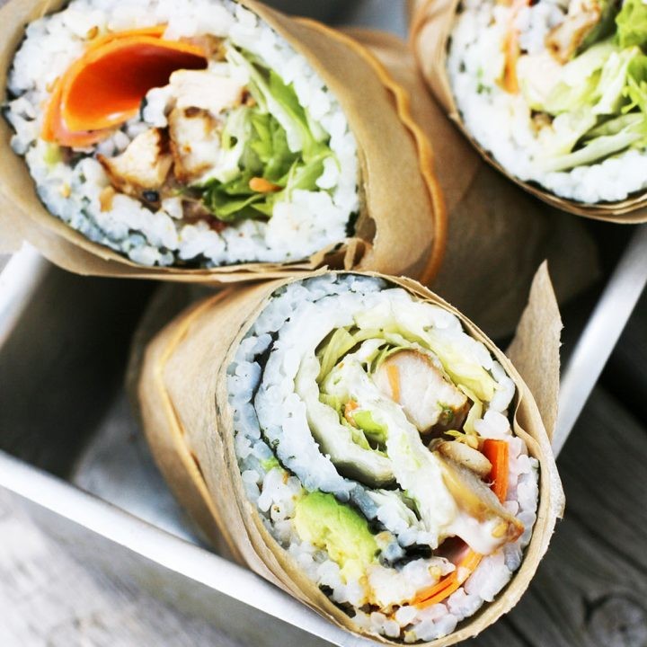 Close-up shot of a Buffalo Chicken Sushi Burrito, showcasing the vibrant colors and textures.