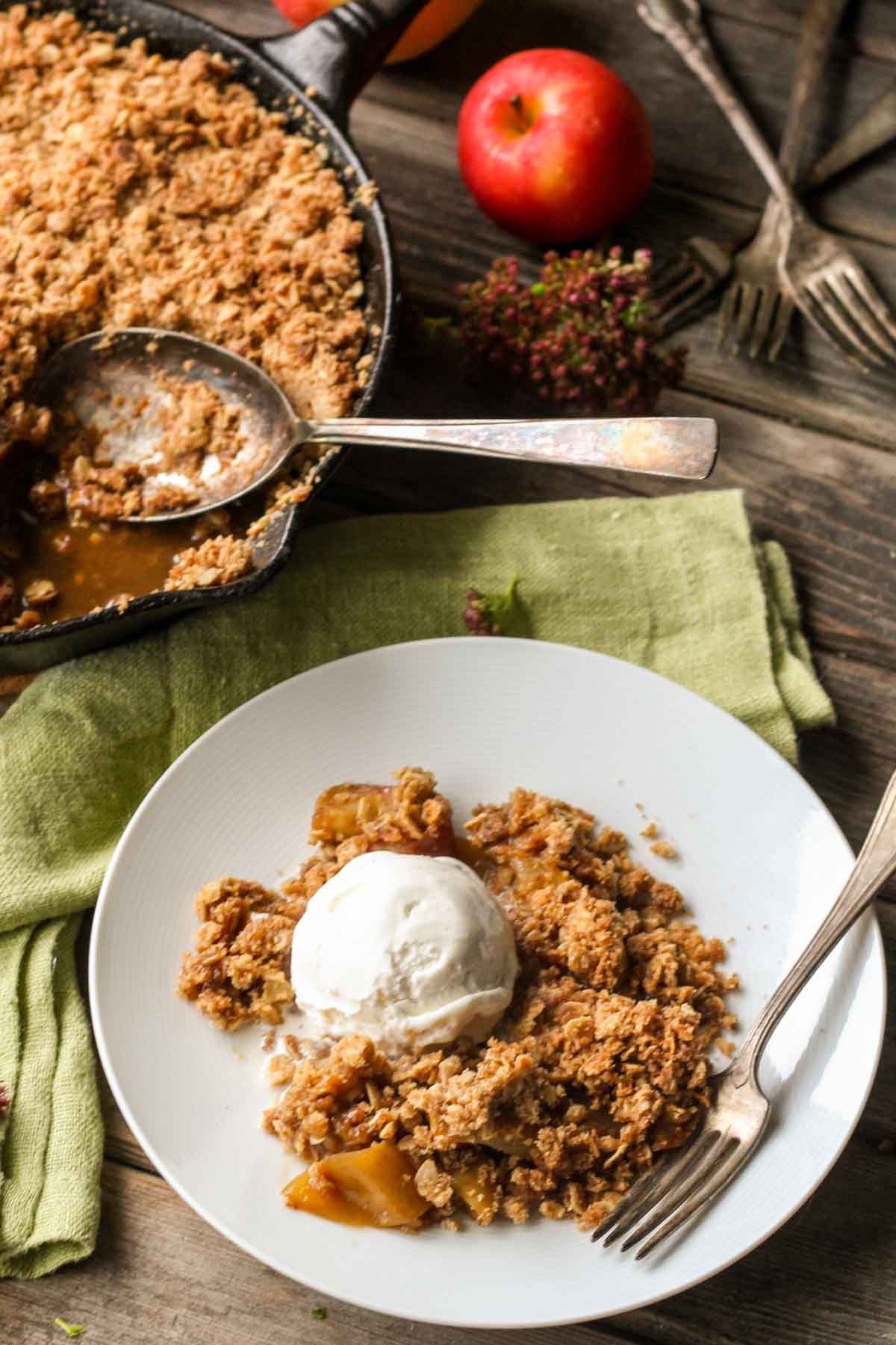 rustic apple crisp with cinnamon on a wooden table, warm lighting