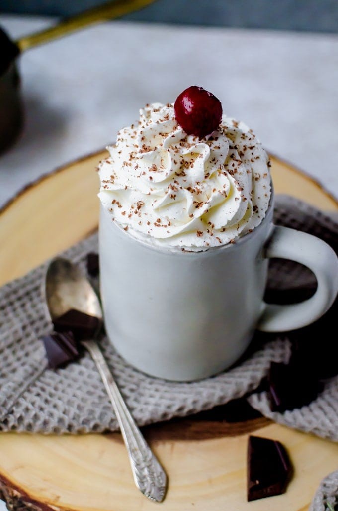 Steaming mugs of Black Forest Hot Chocolate with Kirsch and chocolate shavings