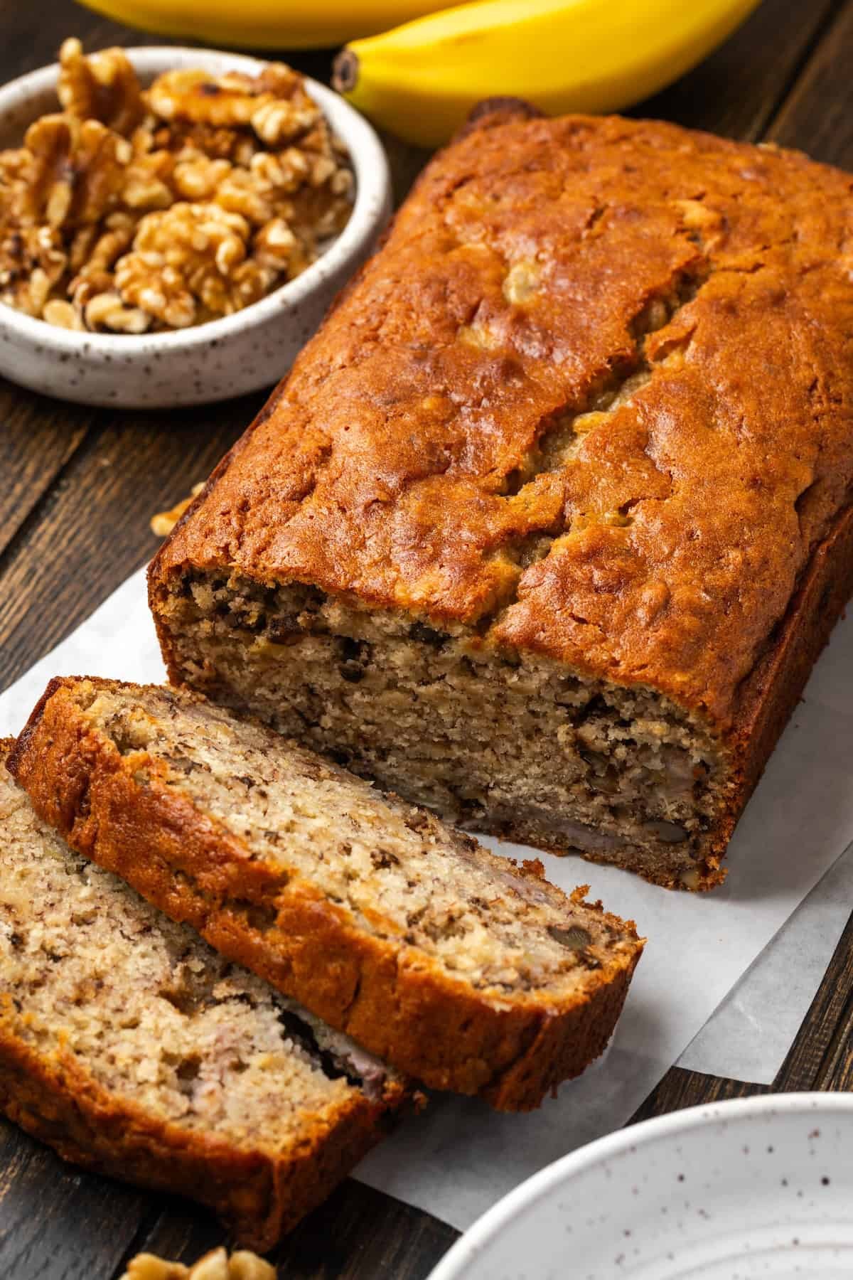freshly baked banana walnut bread cooling on a wire rack with slices cut