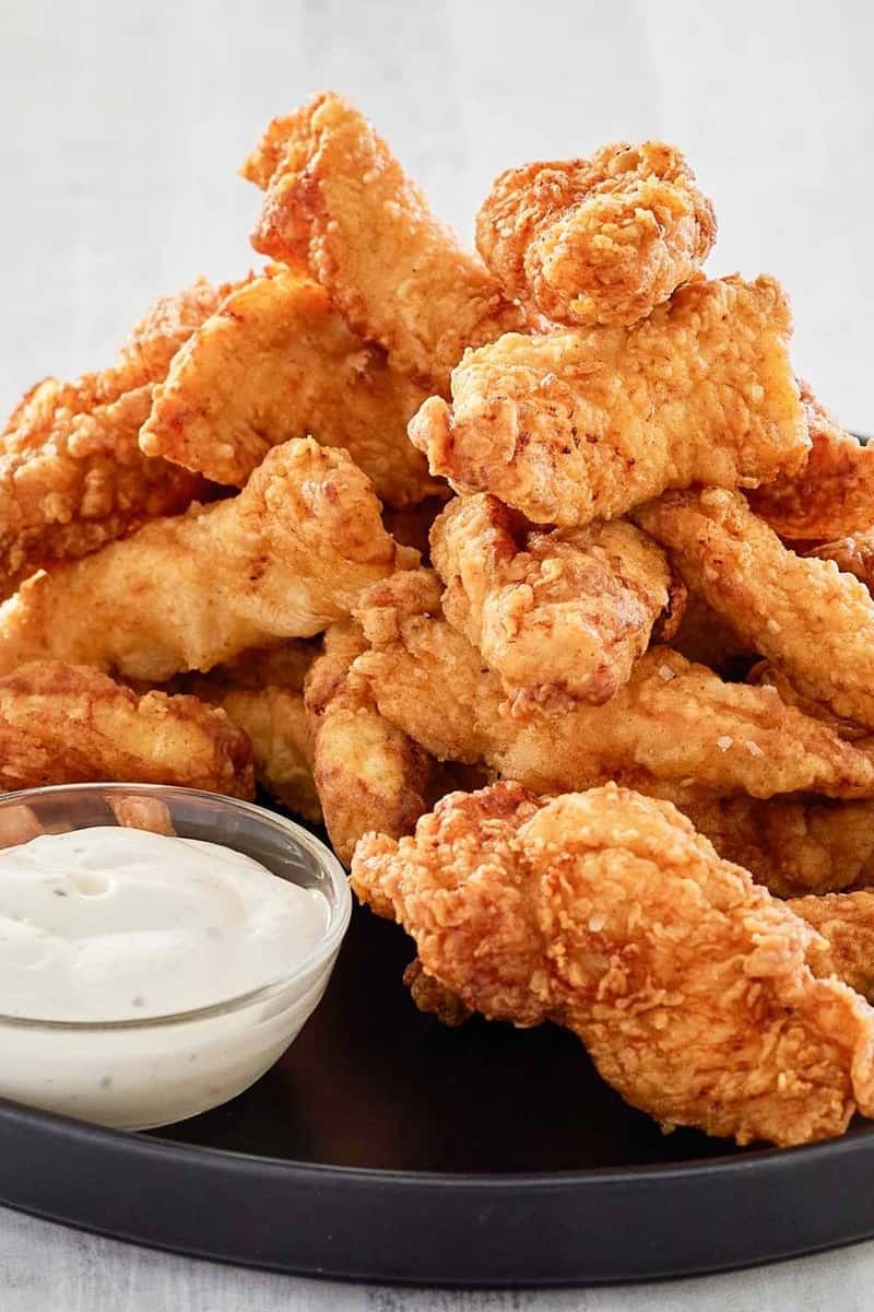 crispy beer battered fried chicken on a pub table
