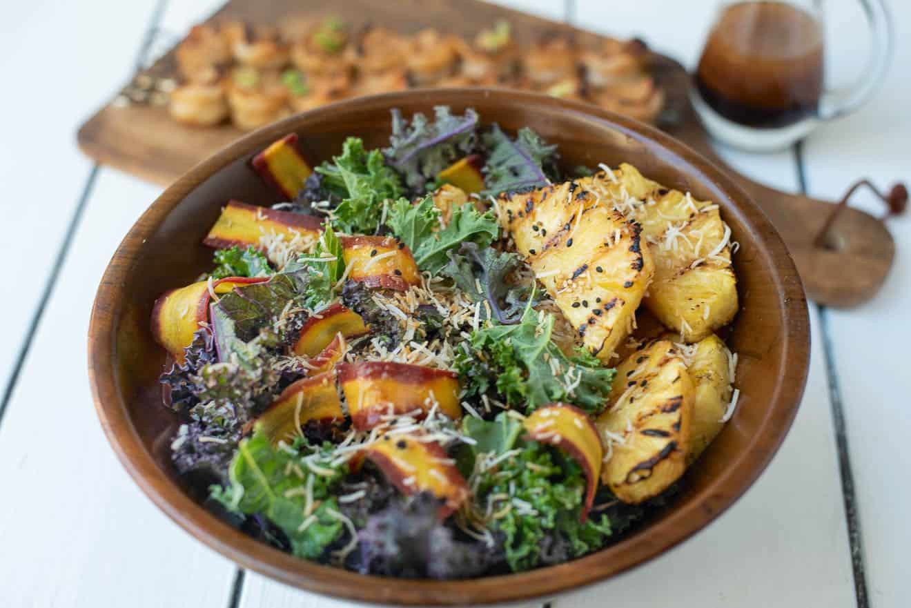 Close-up shot of a vibrant Grilled Pineapple and Coconut Fattoush salad with grilled pineapple chunks, toasted pita bread, fresh herbs, and a creamy coconut dressing.