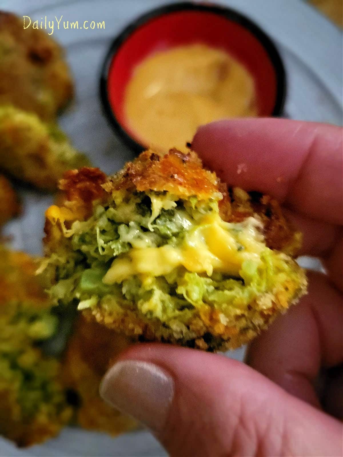 close up shot of golden brown broccoli cheddar bites on a plate