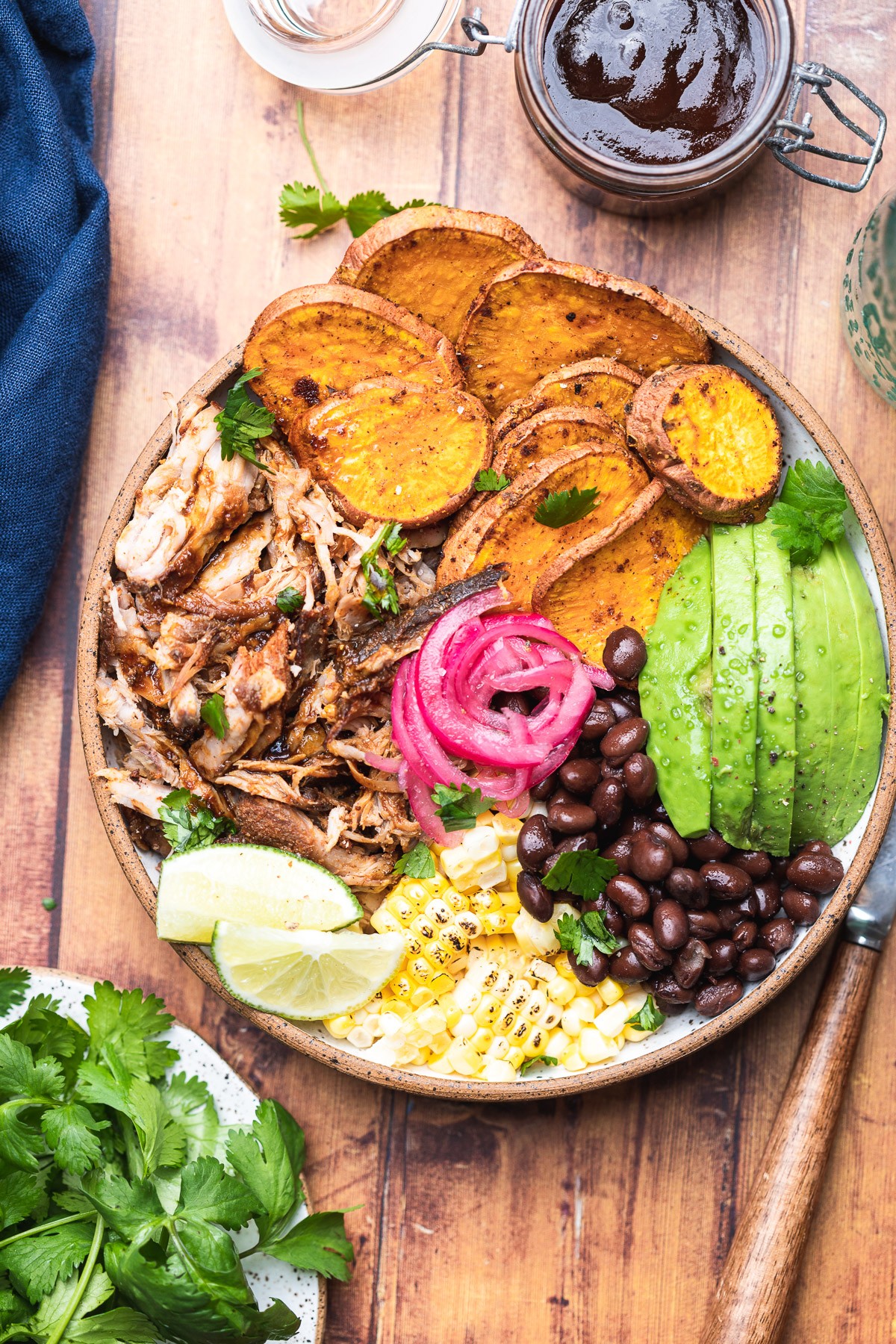 A vibrant and delicious pulled pork protein bowl with various colorful toppings.
