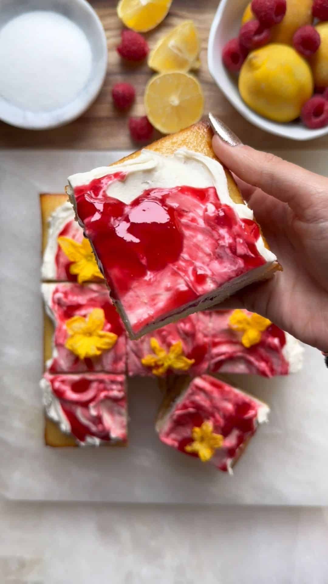 slice of raspberry lemon ricotta cake with fresh raspberries and lemon zest