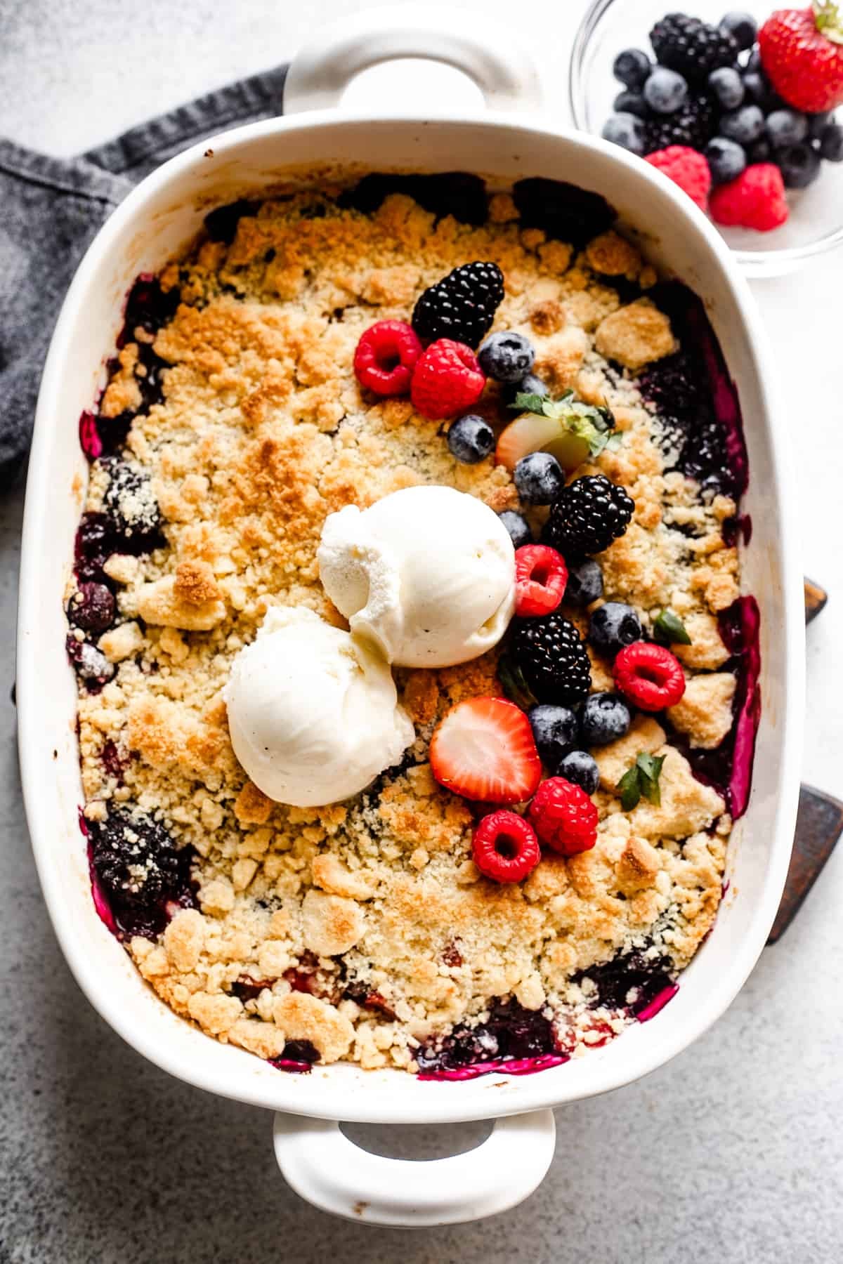 Close-up shot of a delicious homemade berry cobbler, showing bubbly, golden-brown topping and juicy berries bubbling underneath