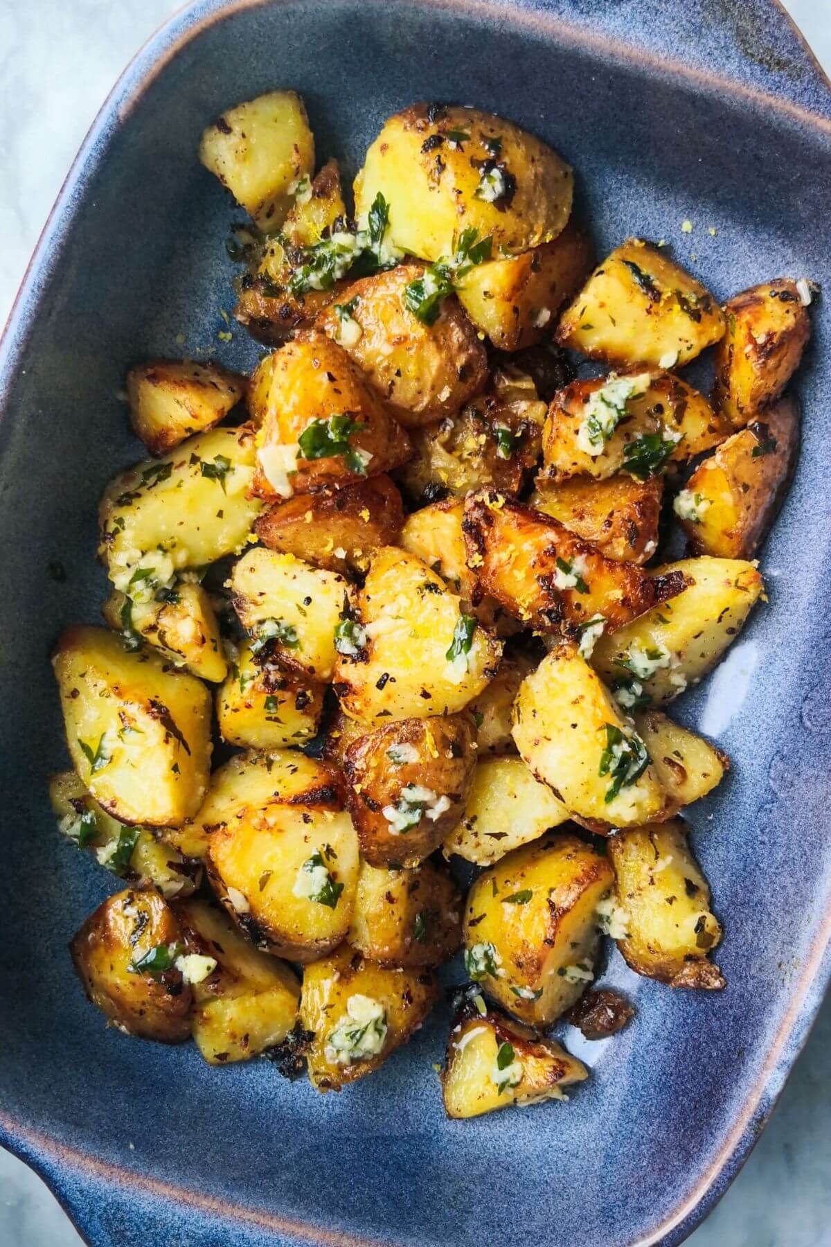 garlic butter herb roasted potatoes on a platter
