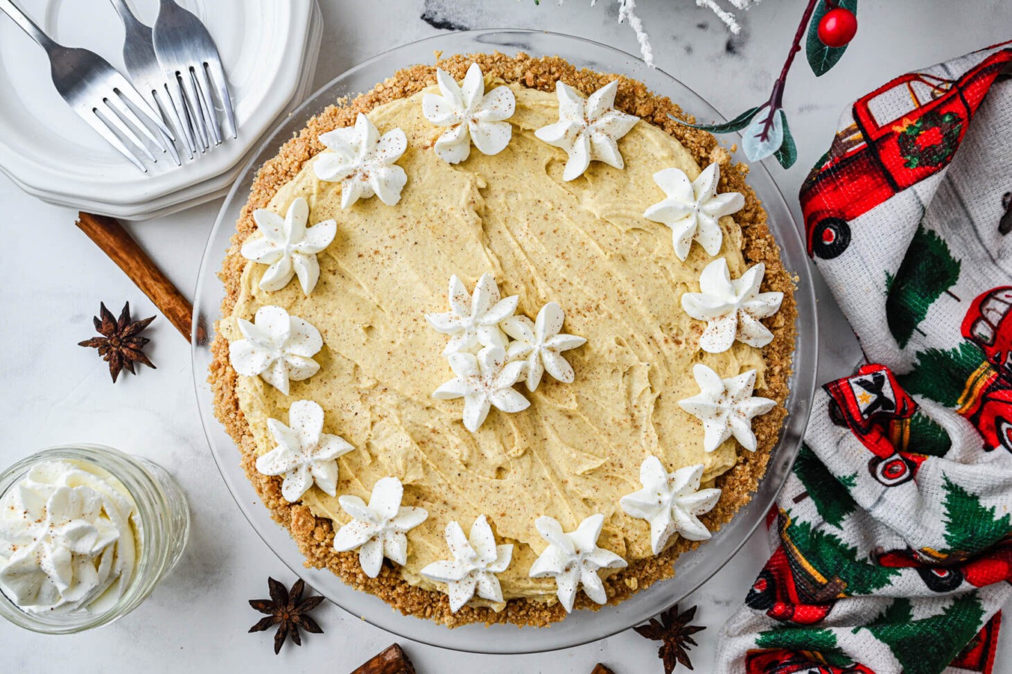 Decadent eggnog pie with a creamy filling, golden crust, and a generous topping of whipped cream and grated nutmeg, festive holiday dessert