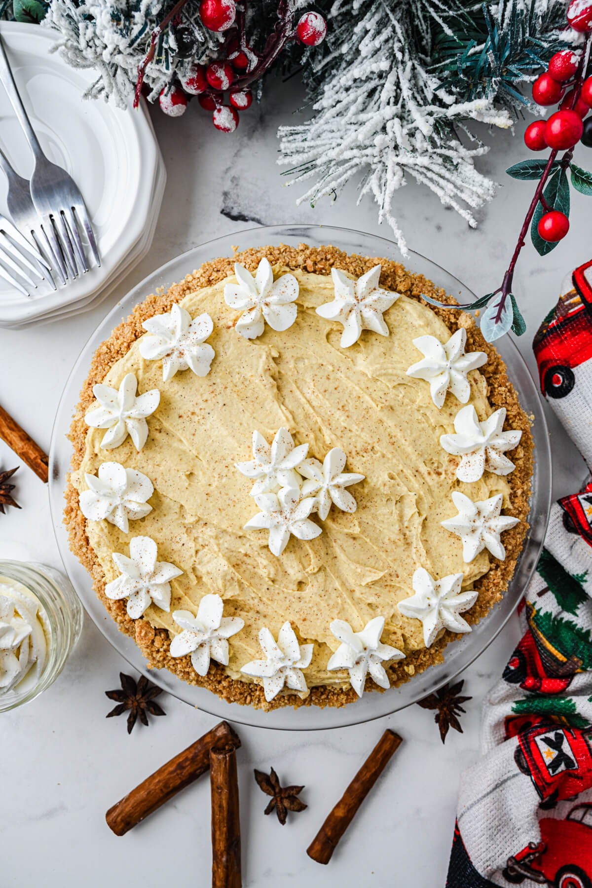 Eggnog pie with fluffy nutmeg topping on a festive table