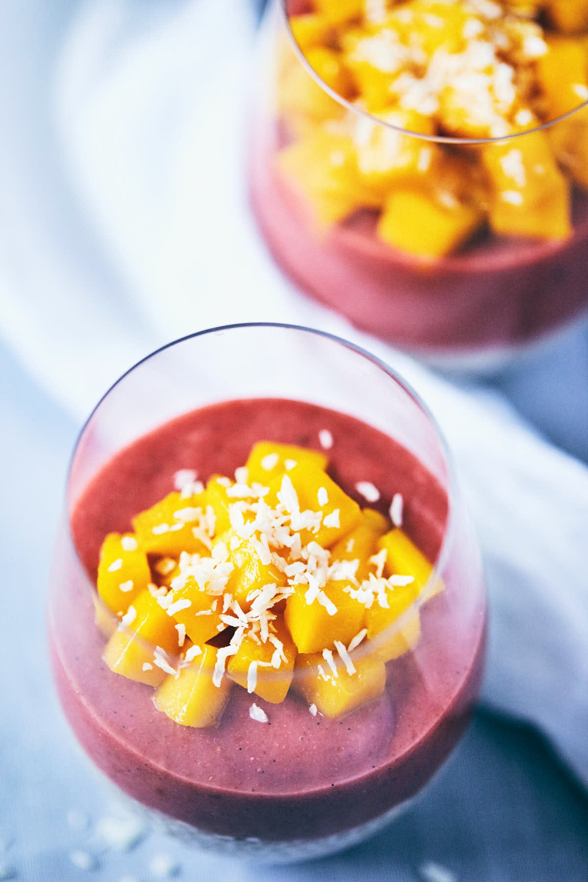 layered guava passionfruit chia seed pudding in a glass